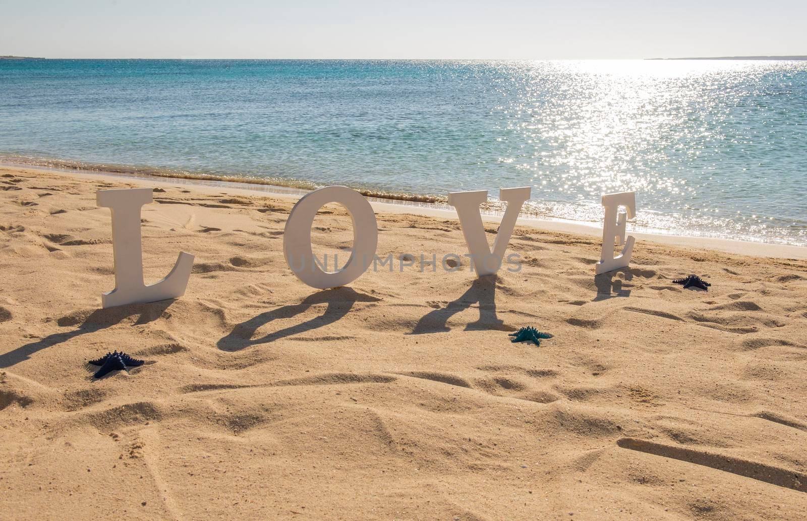 Romantic love sign on a tropical beach paradise by paulvinten