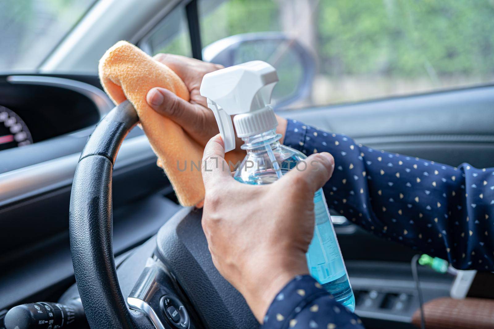 New Normal, Asian working woman clean in car by press blue alcohol sanitizer gel for protect safety Coronavirus.
