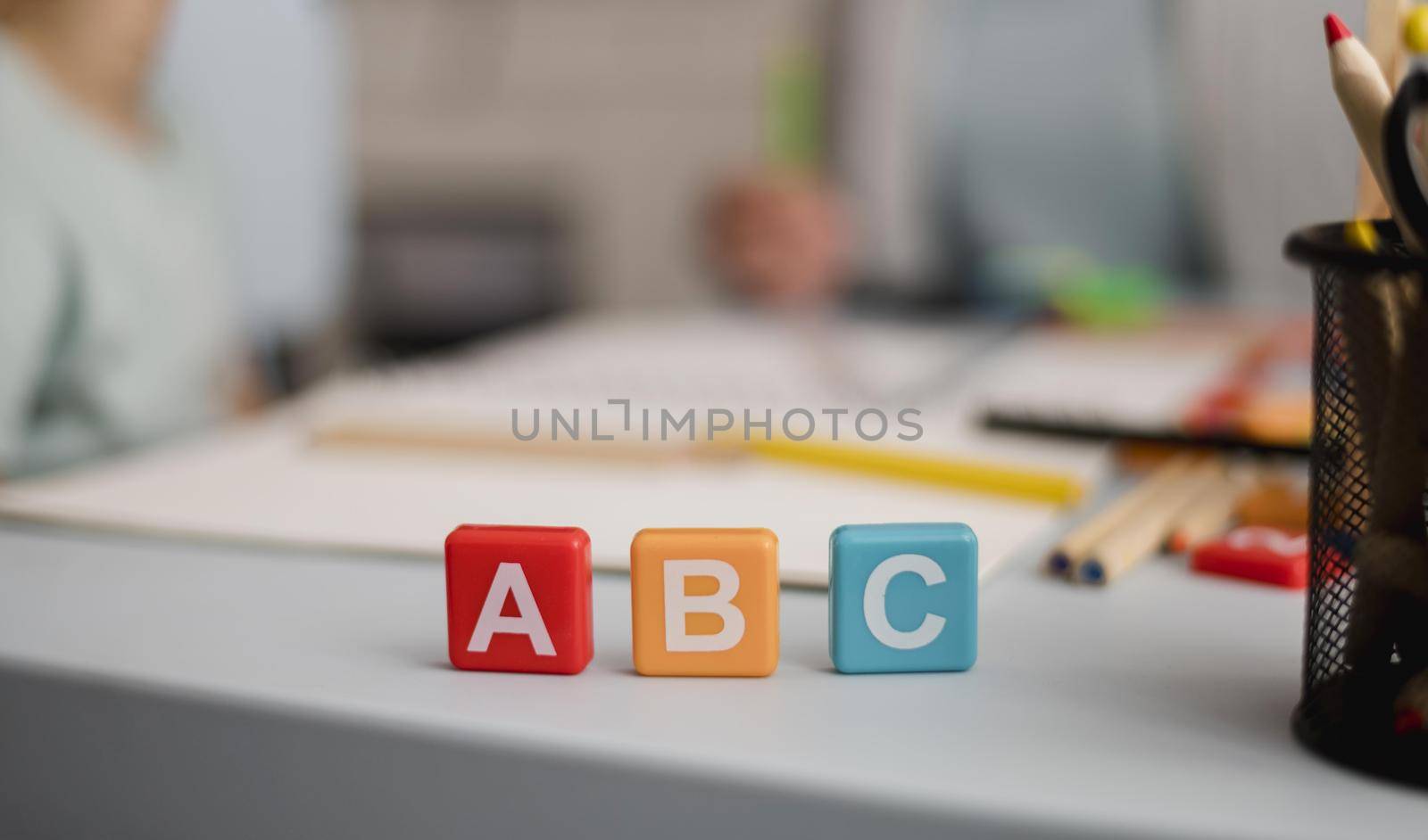 front view letters cubes with defocused tutoring session back. Resolution and high quality beautiful photo