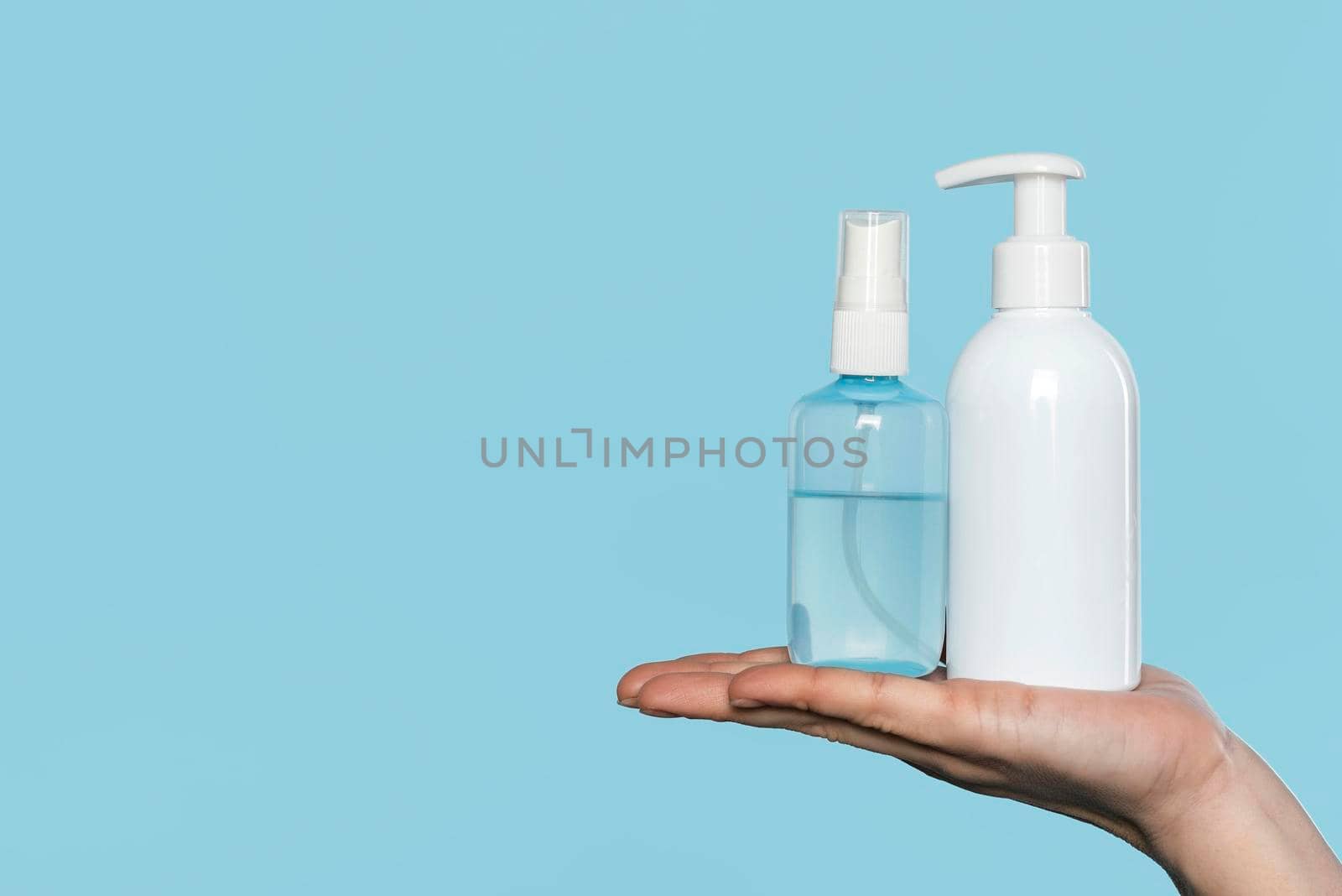 woman holding disinfectant bottles. High quality photo by Zahard