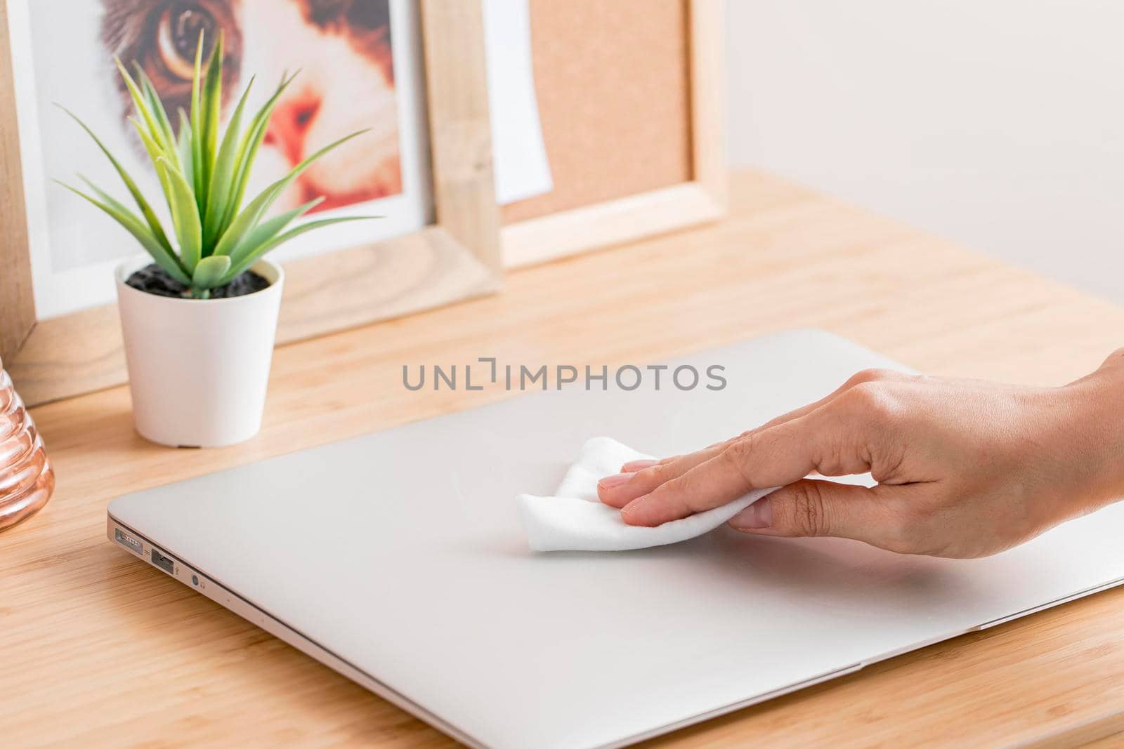 high angle hand disinfecting laptop desk. Beautiful photo