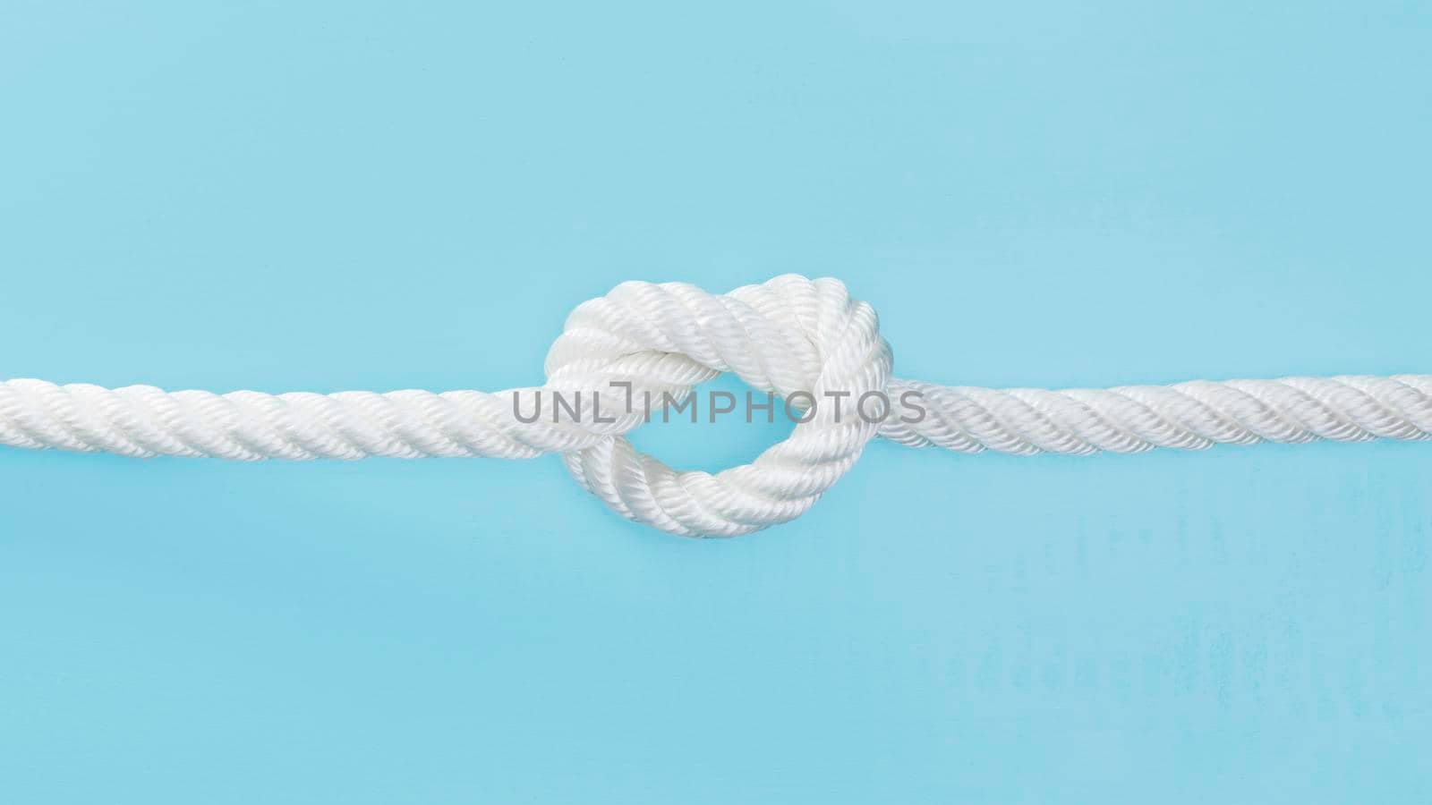 white solid rope with knot. High quality photo by Zahard