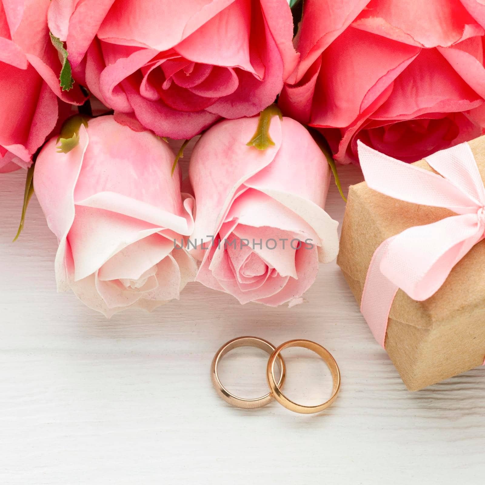 close up pink roses wedding rings. High quality photo by Zahard
