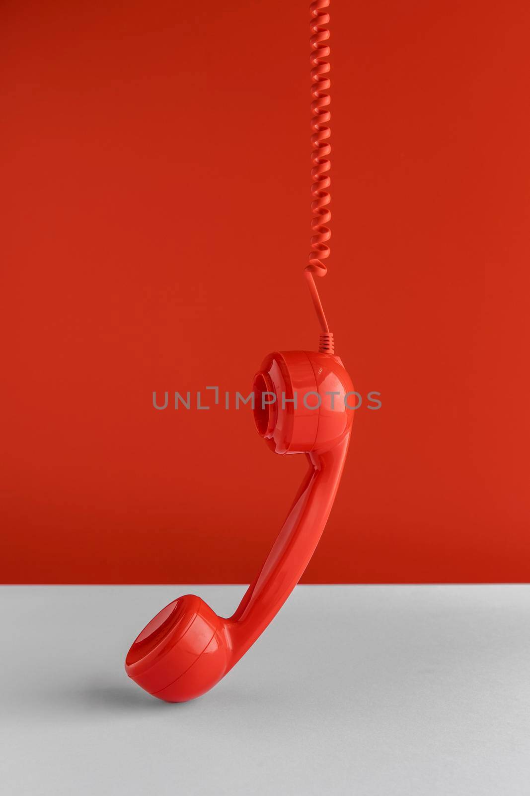 front view telephone receiver hanging from cord. High quality photo by Zahard