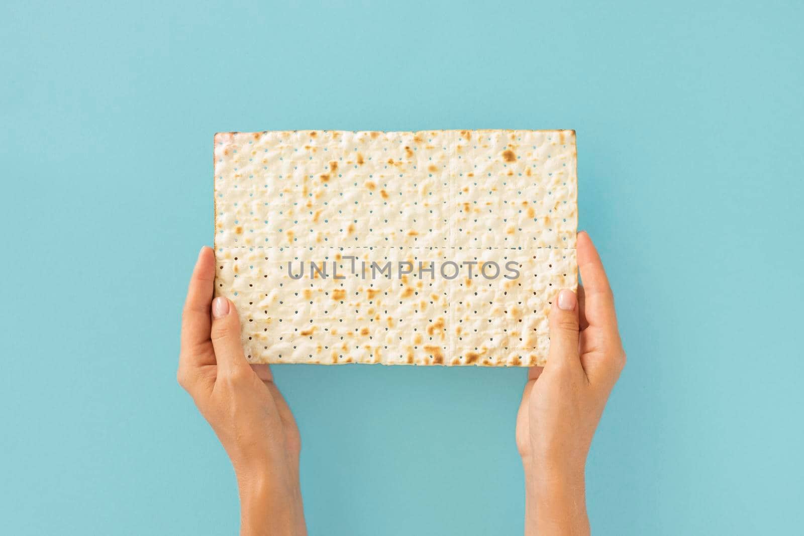 top view hands holding jewish cracker. High resolution photo