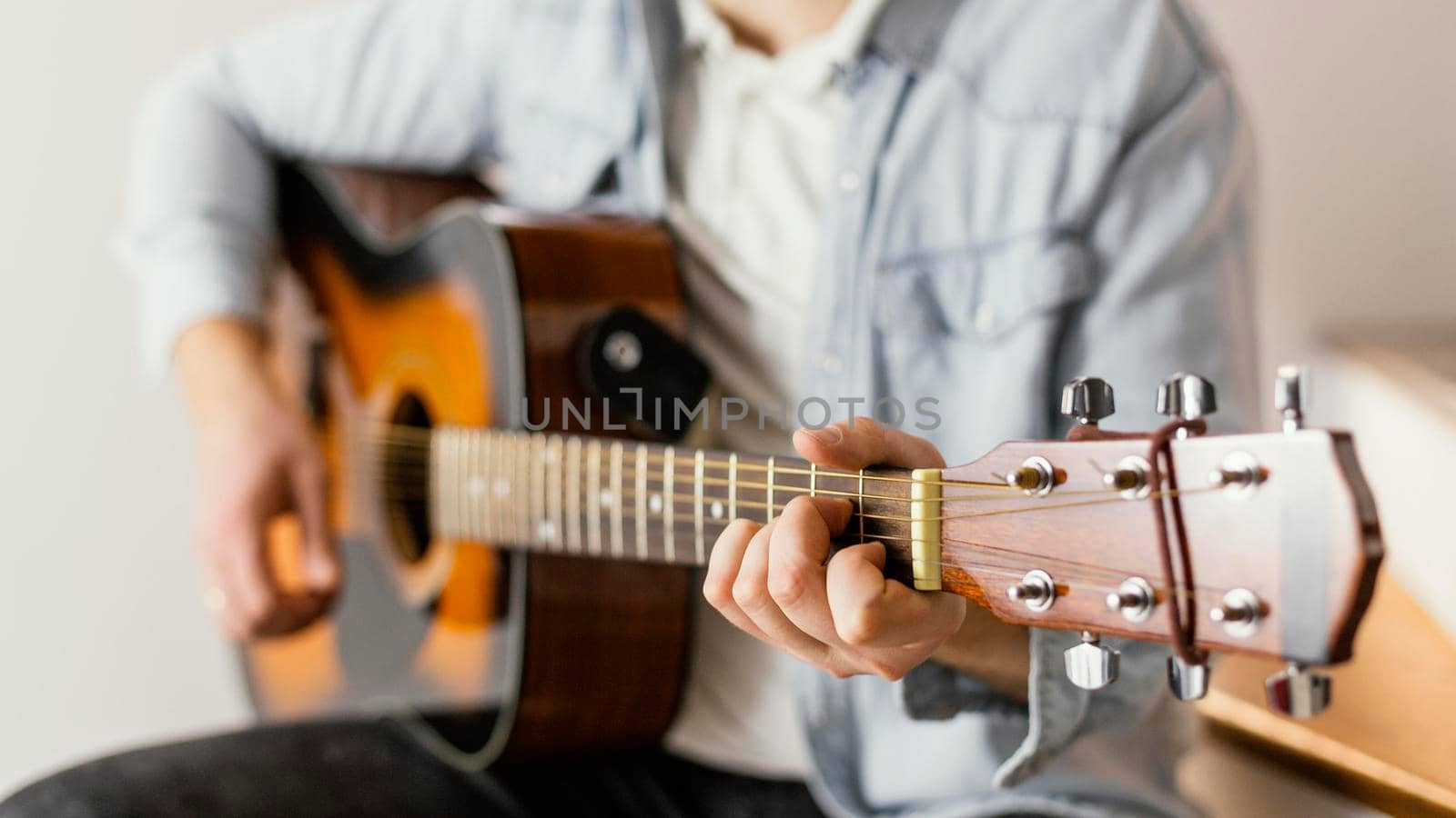 close up musician playing guitar. High resolution photo