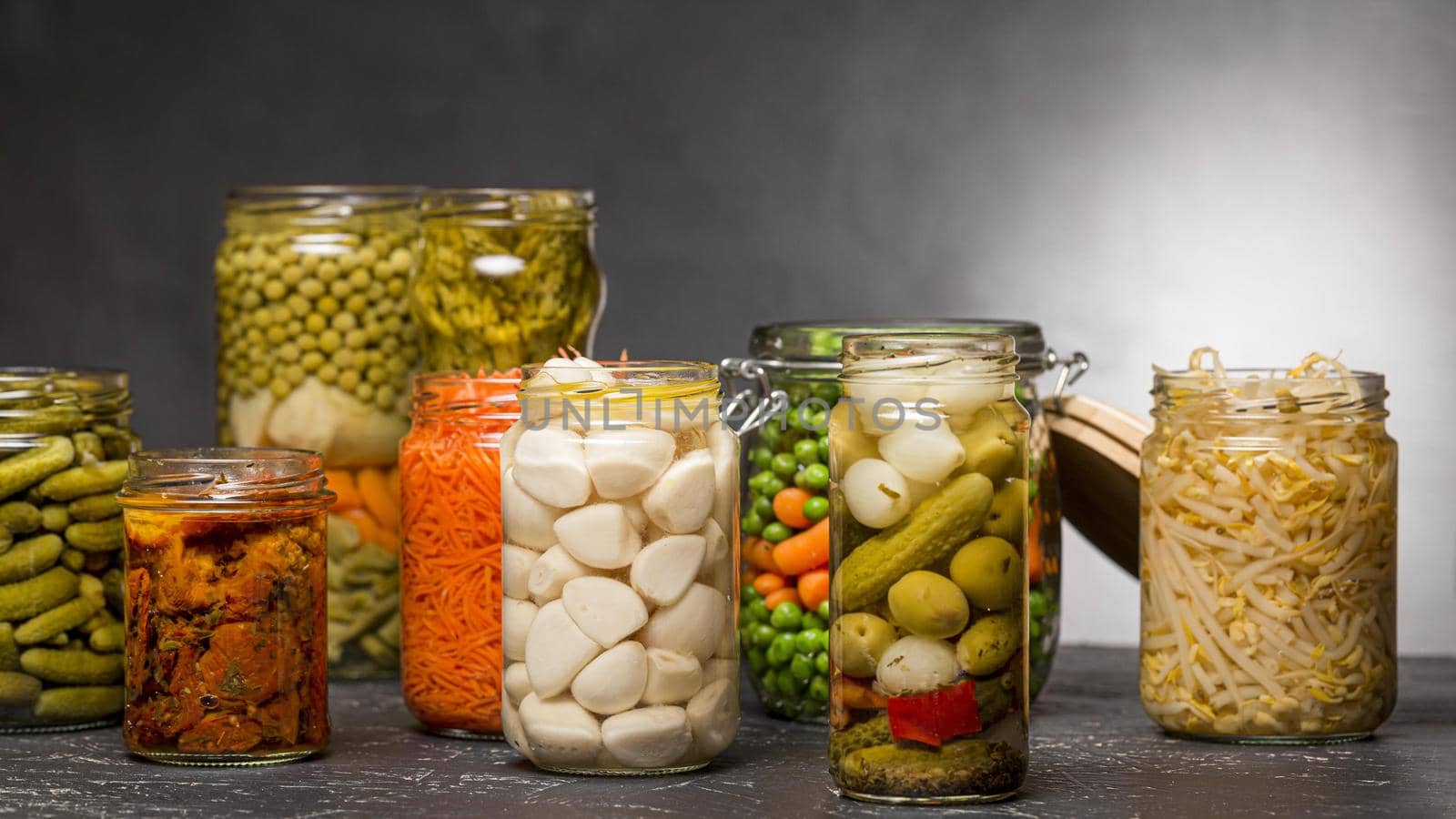 front view assortment vegetables pickled clear glass jars. High quality beautiful photo concept by Zahard