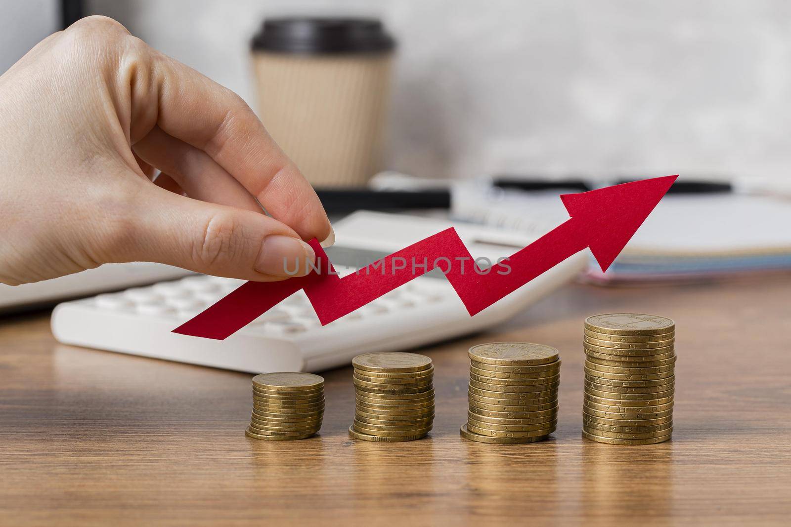 hand holding growth arrow with coins. High quality beautiful photo concept by Zahard