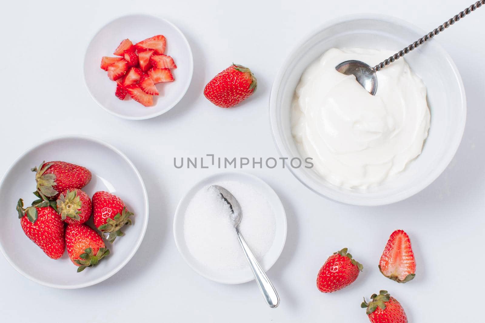 top view yogurt bowls with strawberries table. High resolution photo