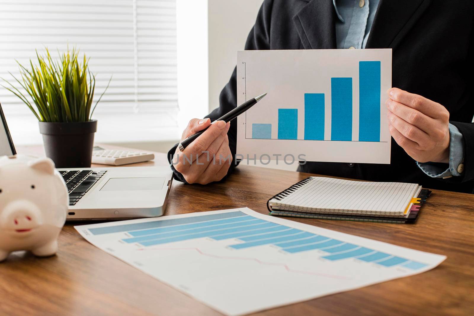 front view businessman holding growth chart. Beautiful photo