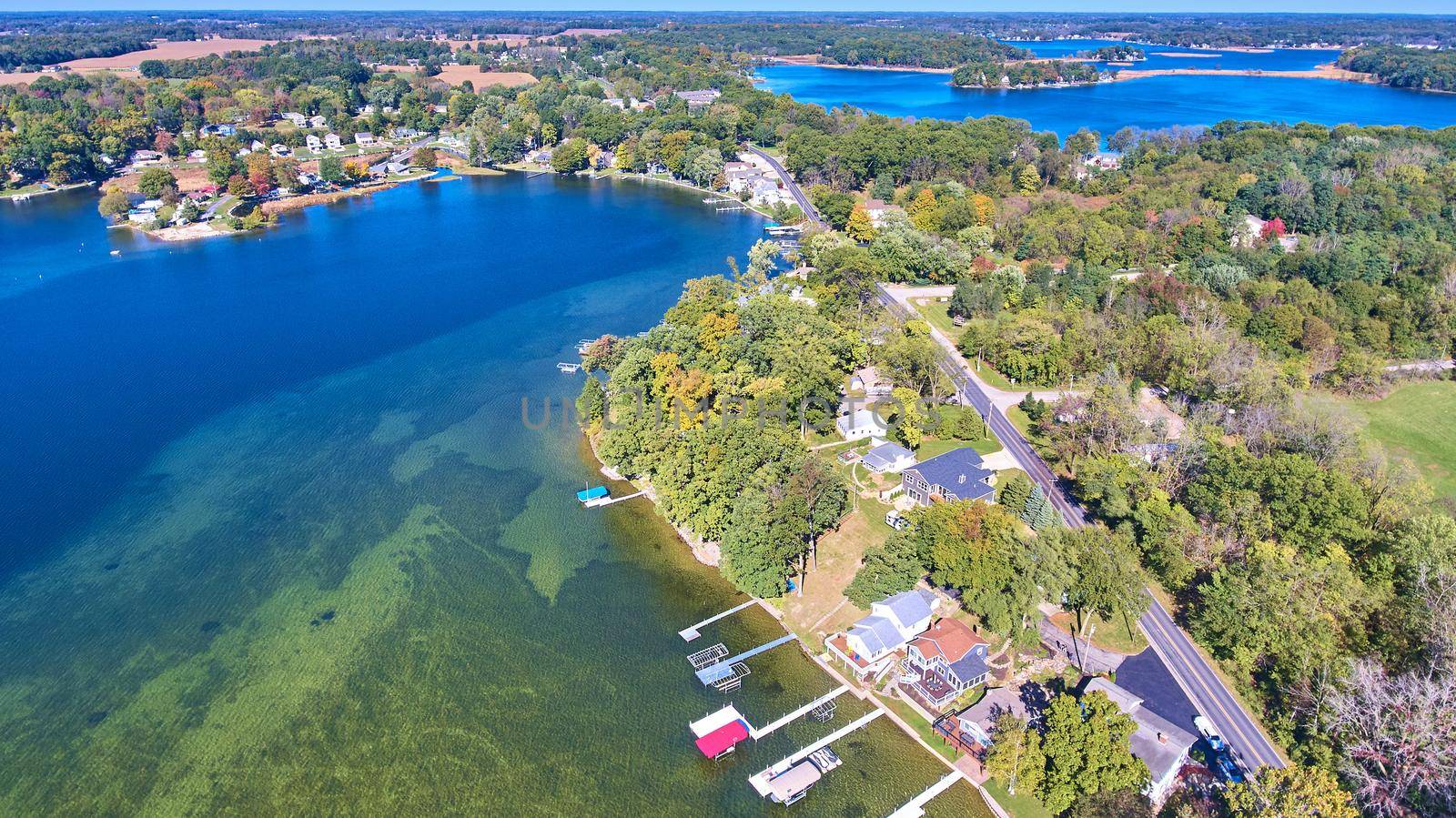 Aerial of large lake lined with docks and lake properties by njproductions