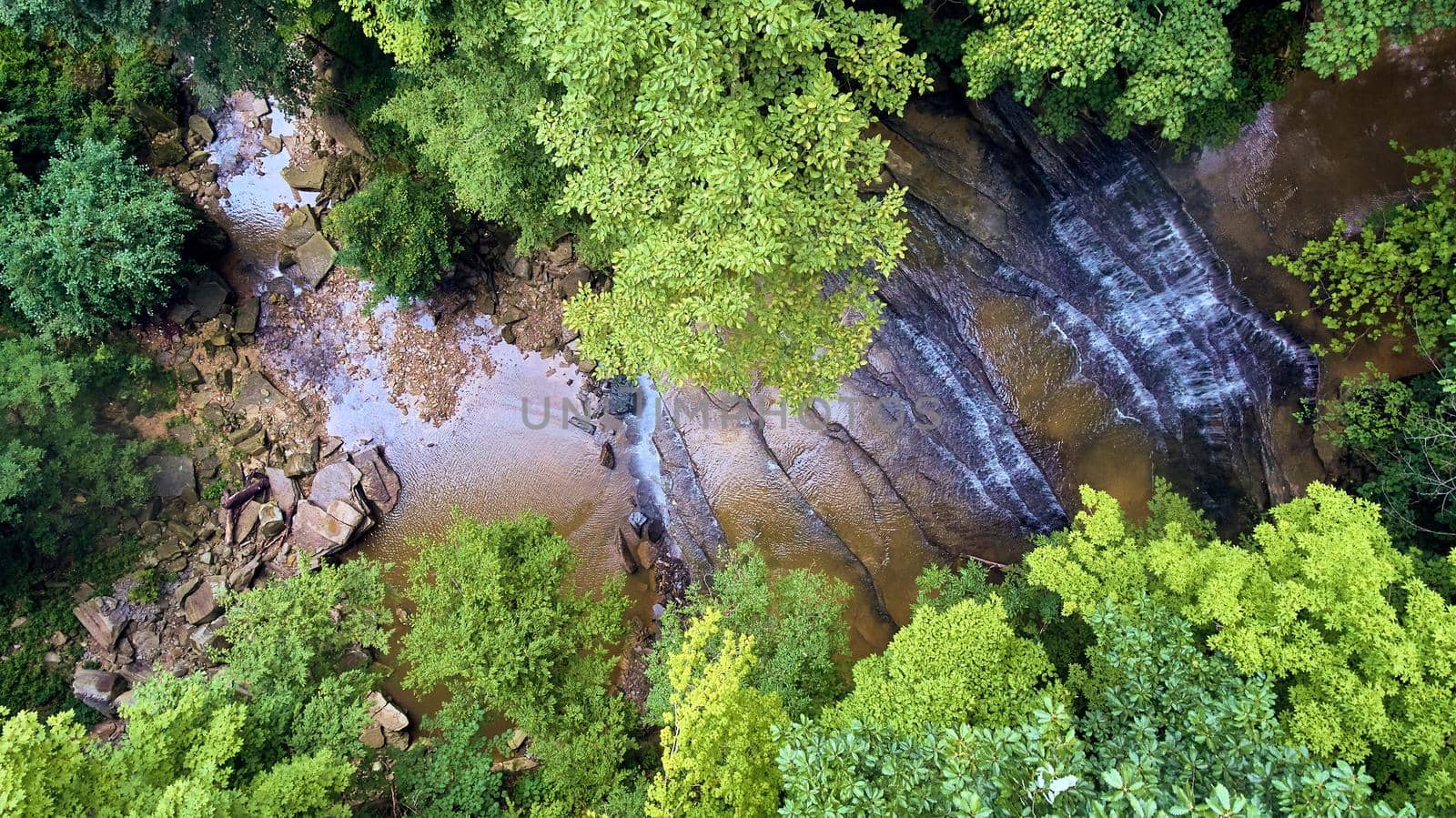 Image of Forest looking down at tiers of rocks and waterfalls into gorge