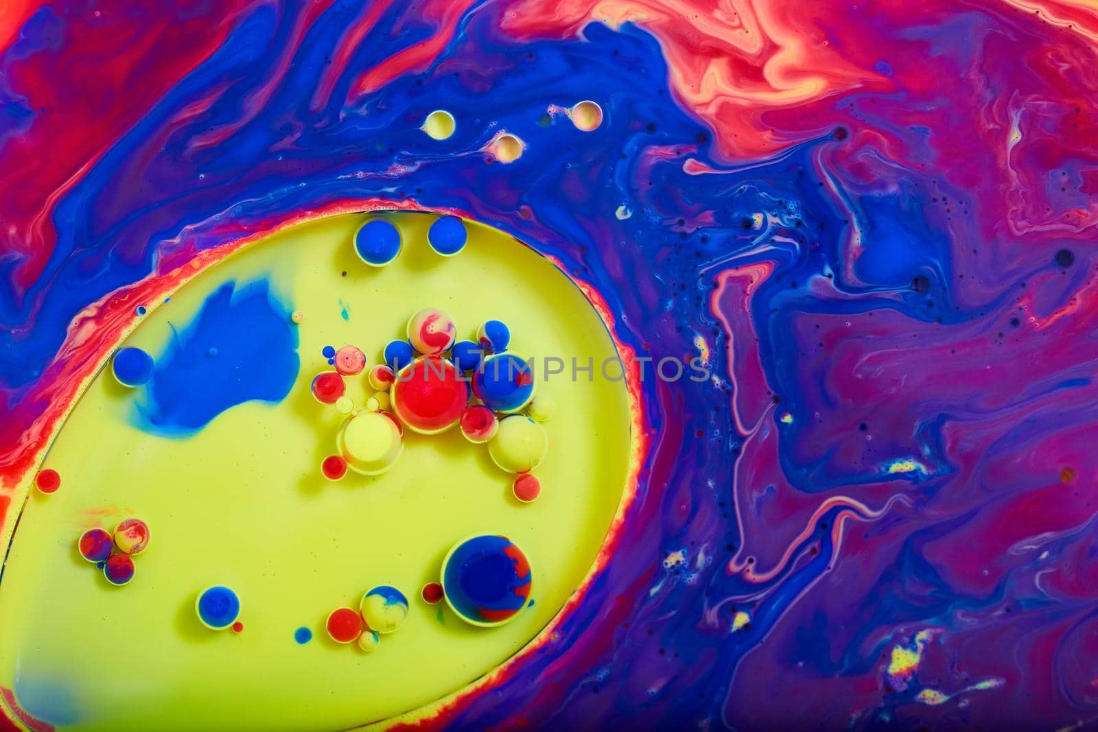 Multicolored surface with circle of yellow and tiny spheres of red, blue, and yellow by njproductions
