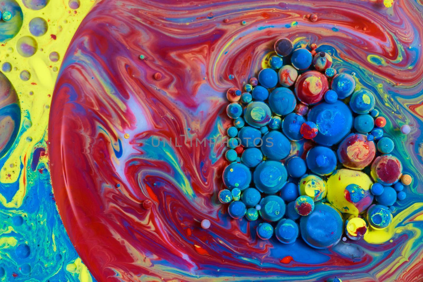 Image of Rainbow circular silky surface with cluster of colorful acrylic orbs