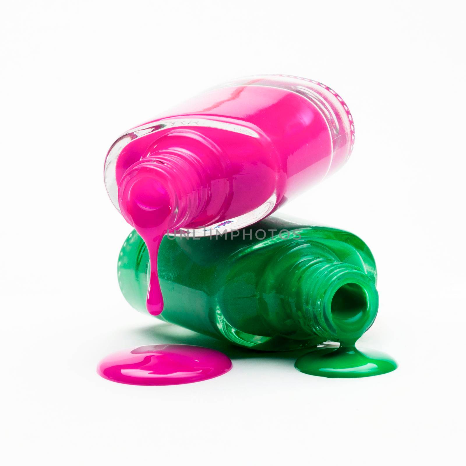 close up pink green nail polish dripping from bottle by Zahard
