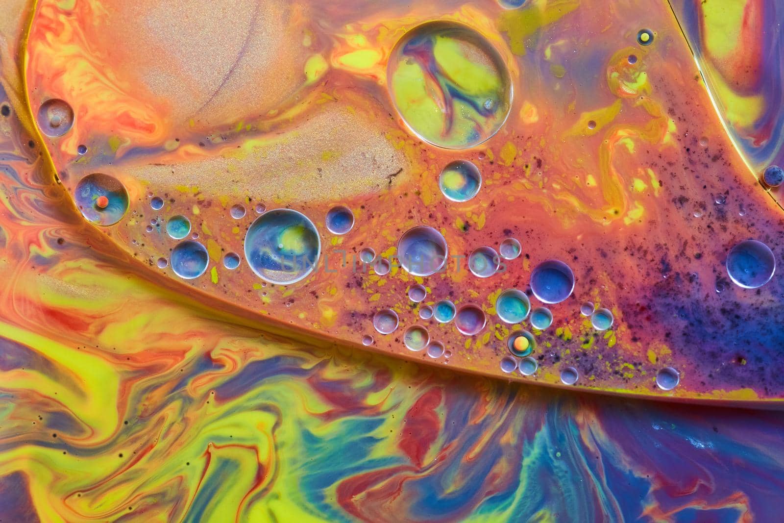 Mysterious liquid of rainbow colors and small shiny spheres by njproductions