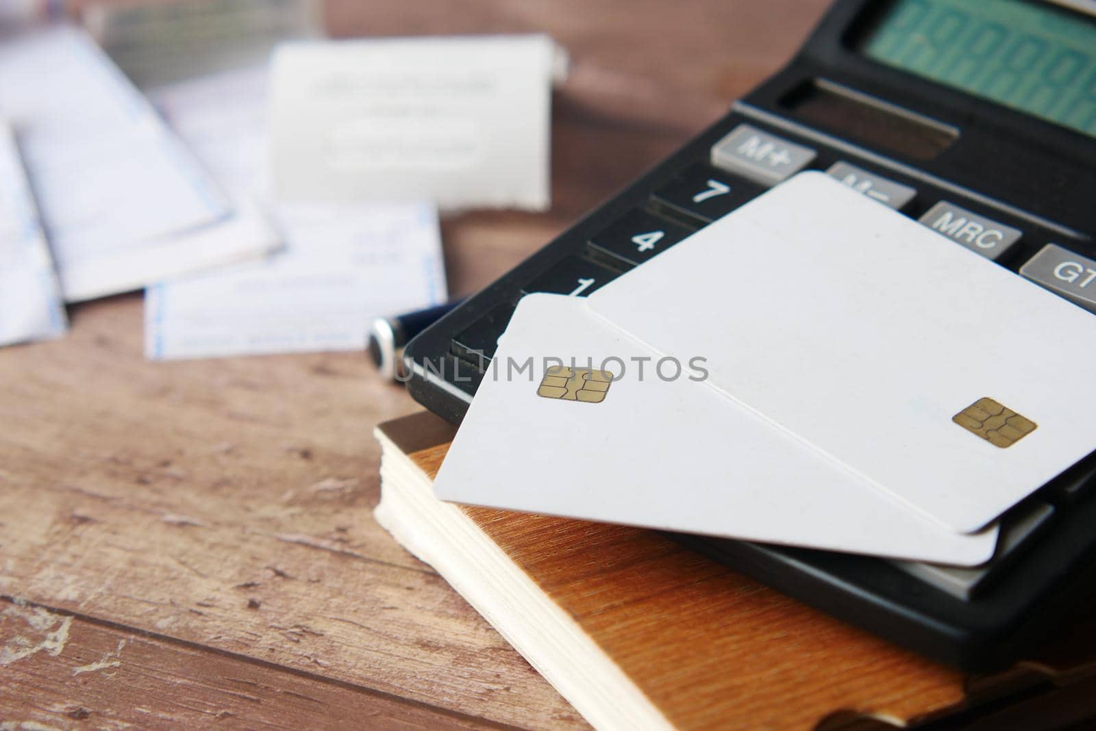 close up of credit cards , calculator and paper on table by towfiq007