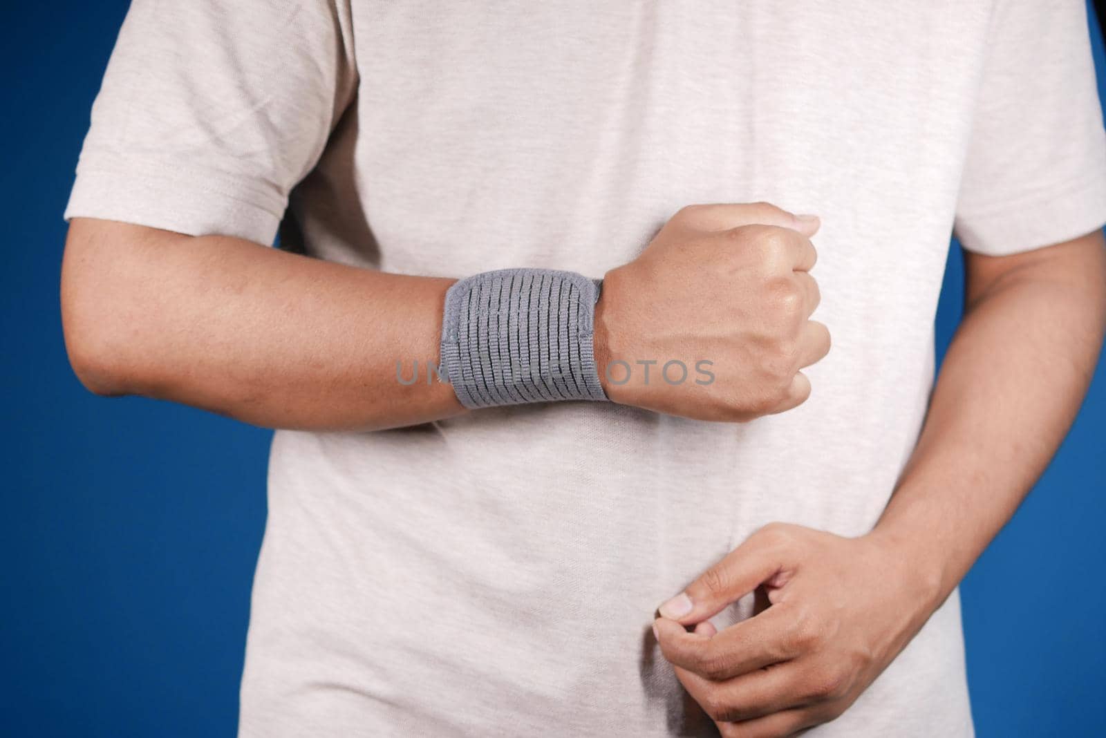 hand with wrist support against blue background. by towfiq007