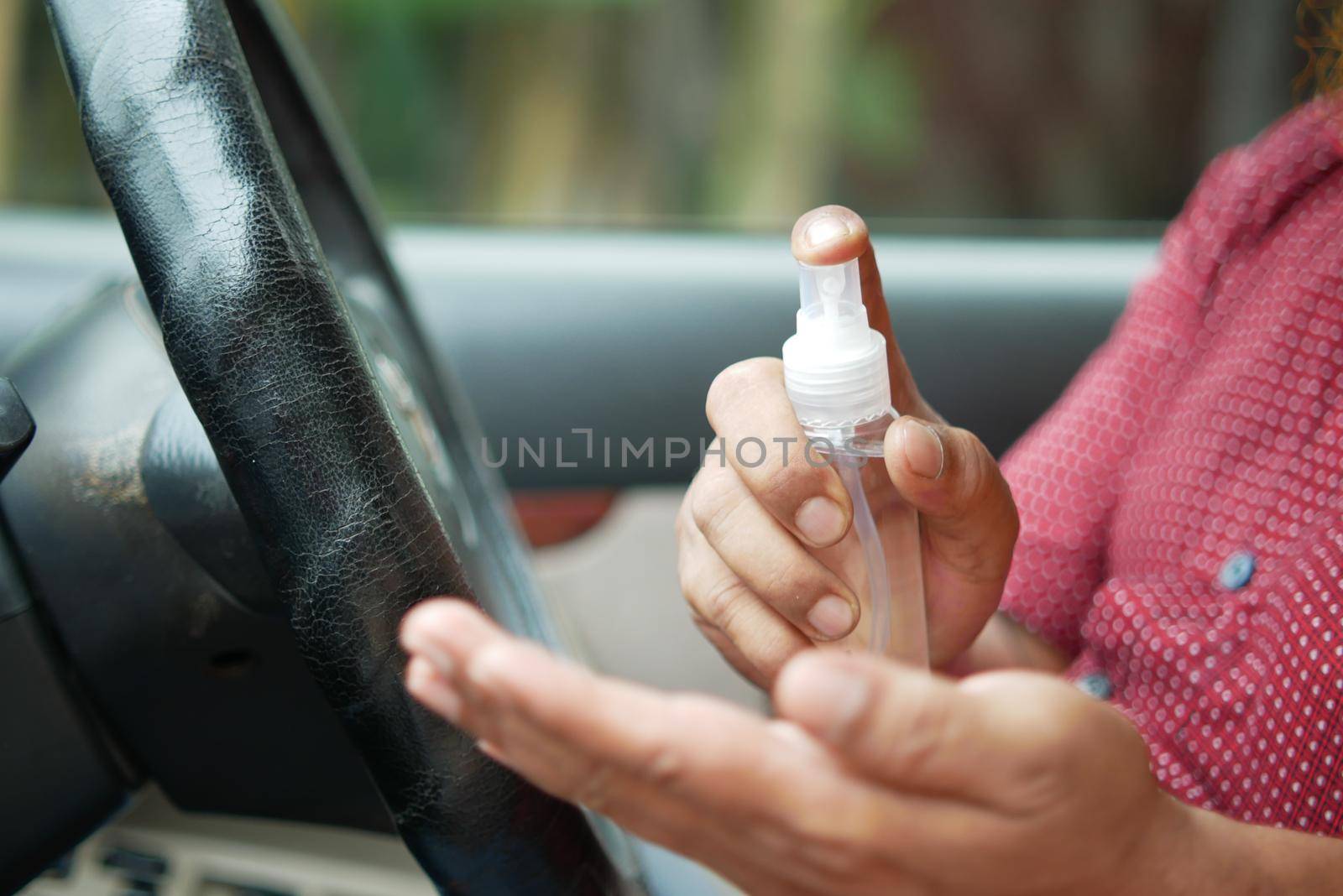 close up of young man hand using hand sanitizer spray