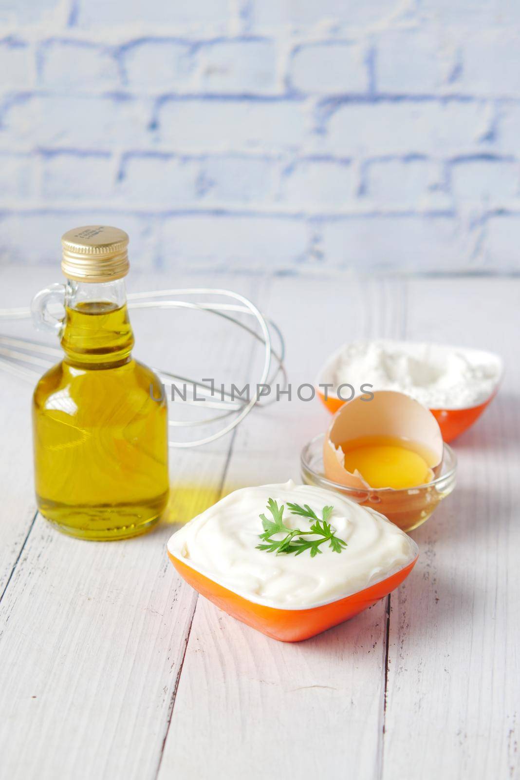 Mayonnaise in container , oil and eggs on table ,