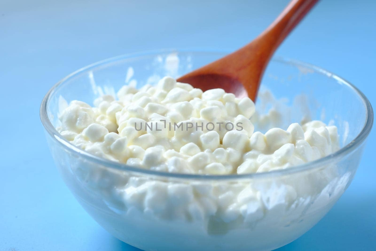 close up of cottage cheese on spoon on table