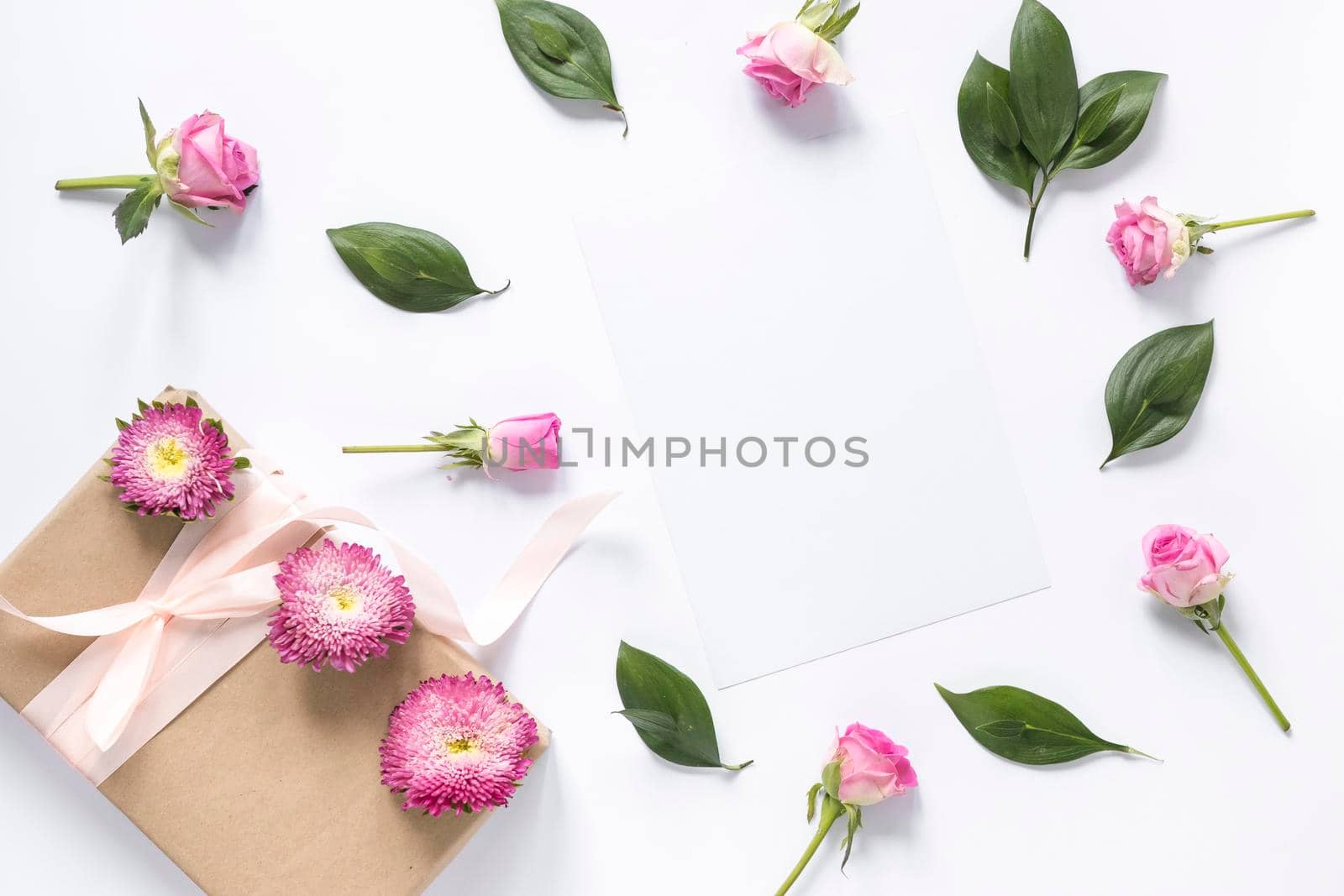 high angle view flowers leaves with gift box white surface. High resolution photo