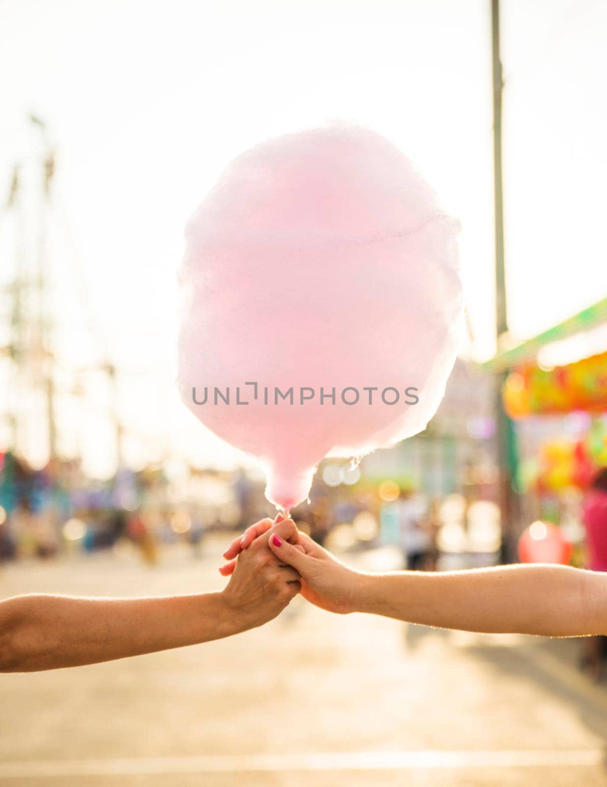 close up two women s hand holding pink candy floss. Beautiful photo