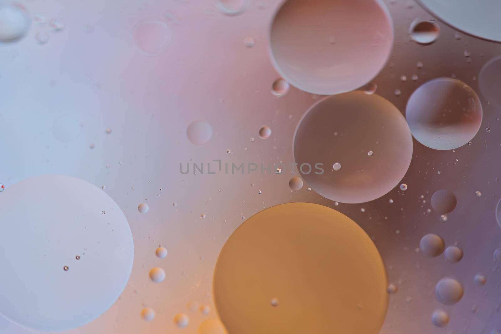 Oil drops in water. Defocused abstract psychedelic pattern image orange and gray colored. Abstract background with colorful gradient colors. DOF.