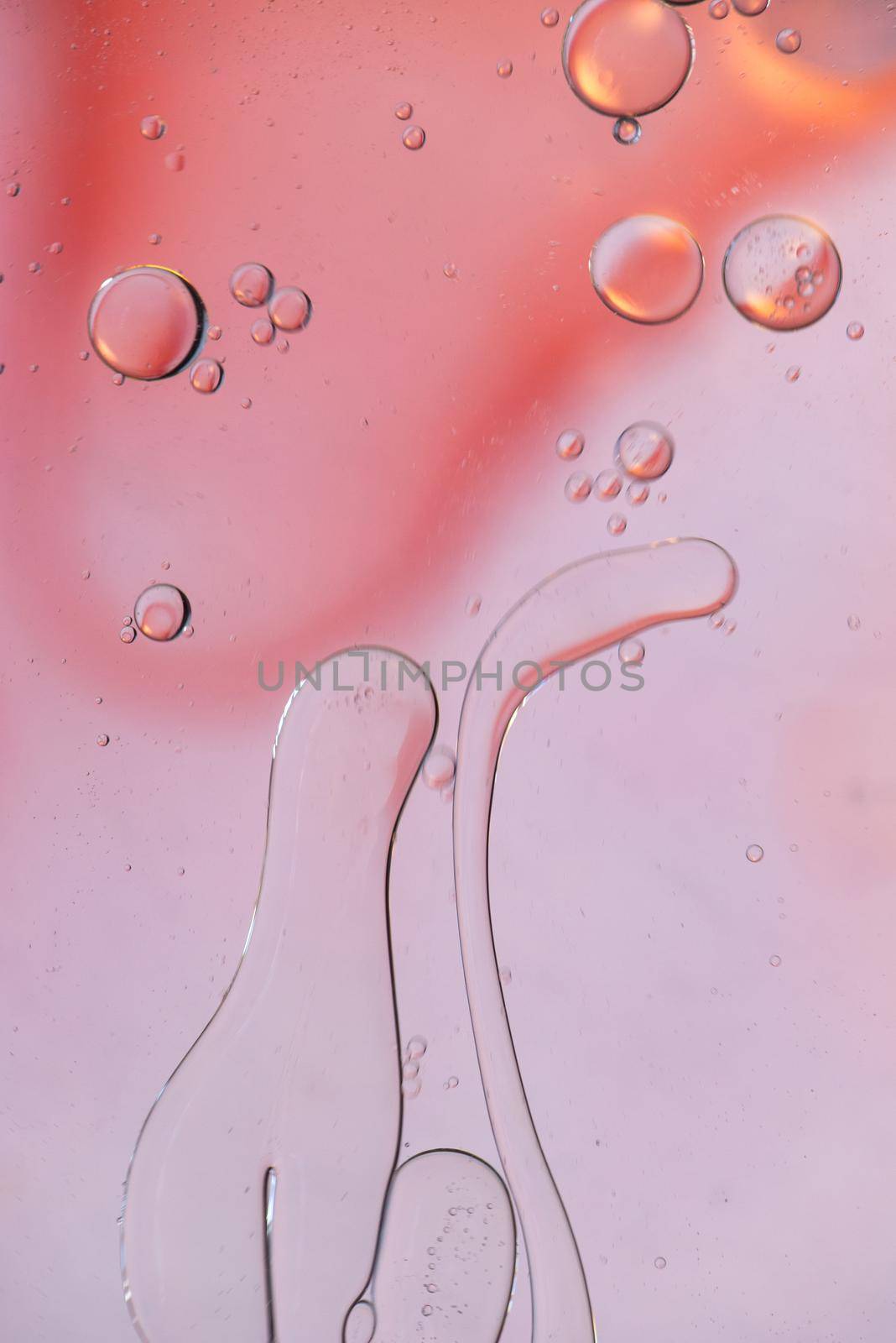 Oil drops in water. Defocused abstract psychedelic pattern image pink colored. Abstract background with colorful gradient colors. DOF.