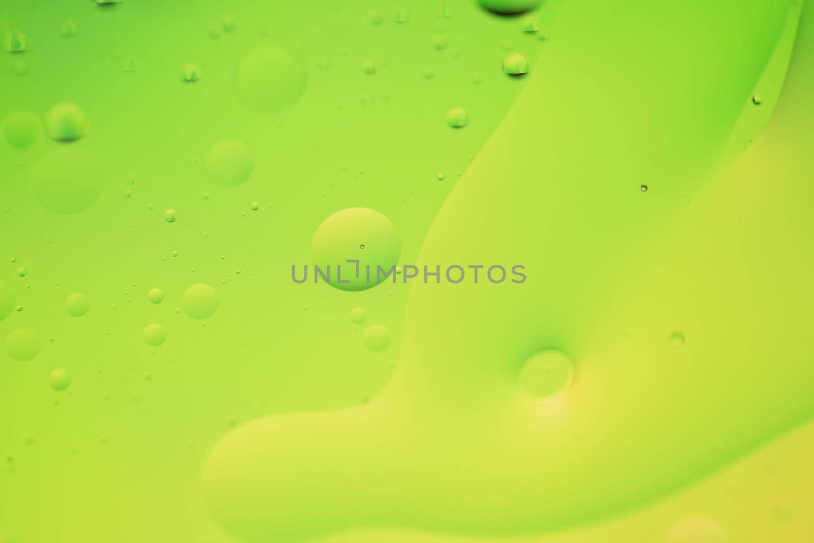 Green and yellow abstract background picture made with oil, water and soap by anytka