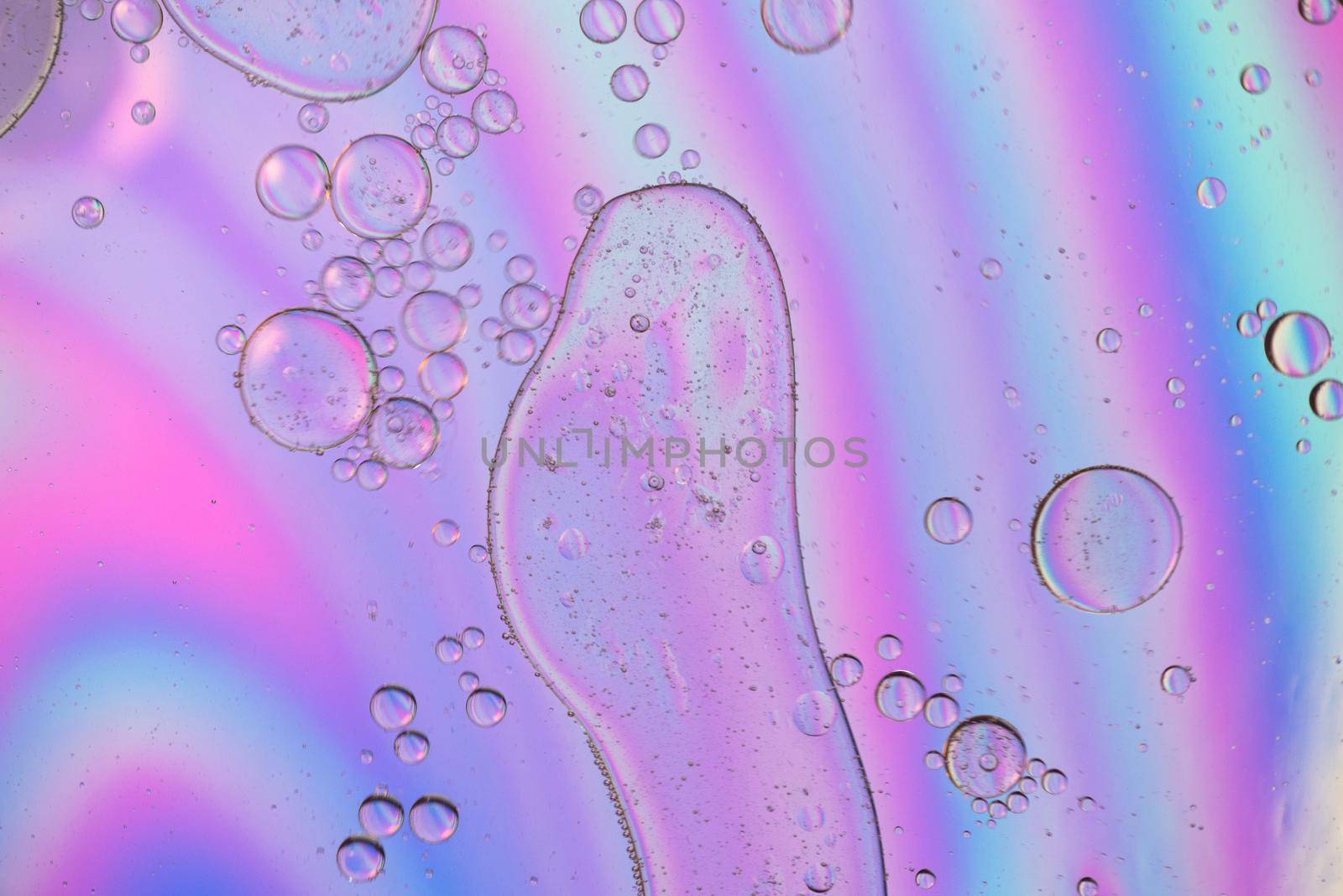 Oil drops in water. Abstract psychedelic pattern image holographic rainbow colored. Abstract background with colorful gradient colors.