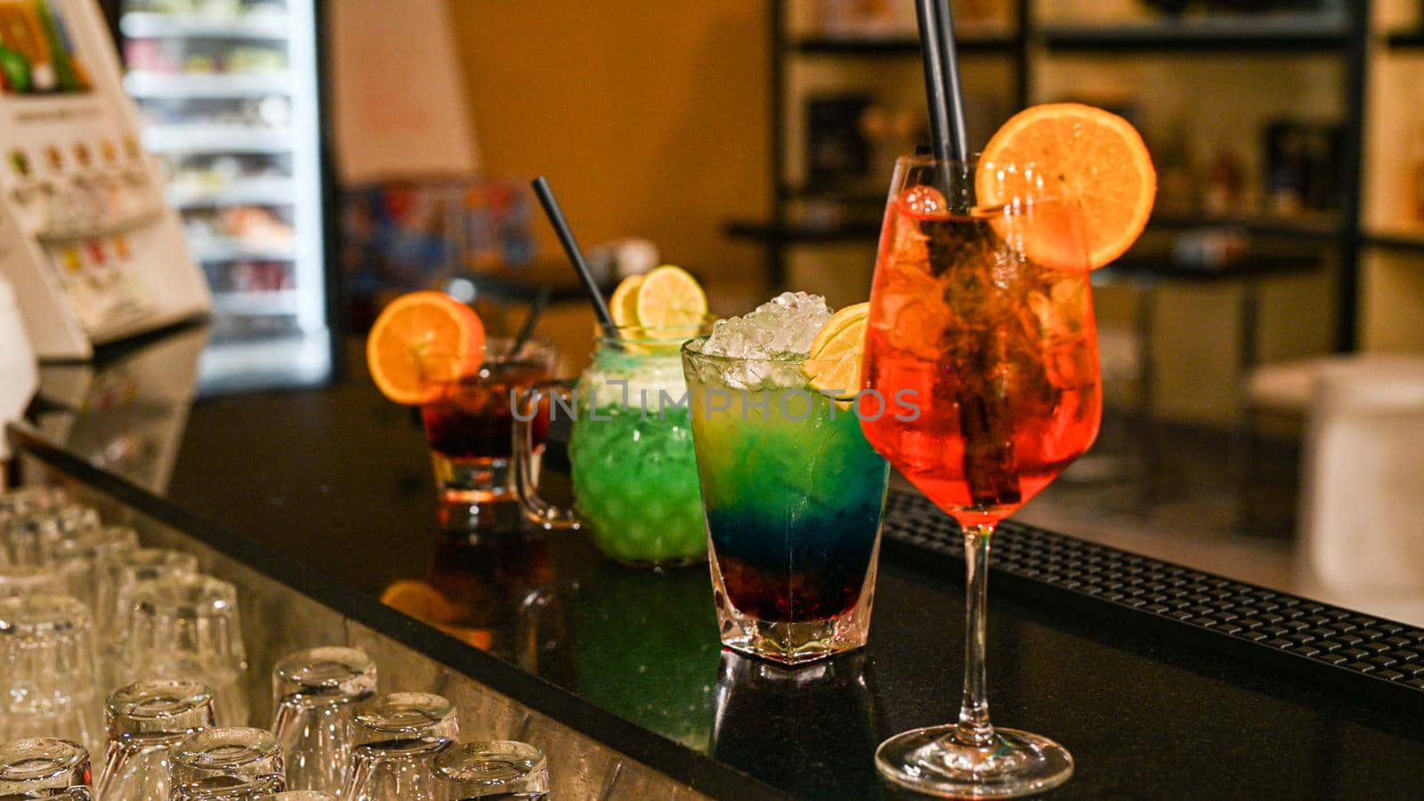 composition of various cocktails on the counter in strong colors and fruit on the head