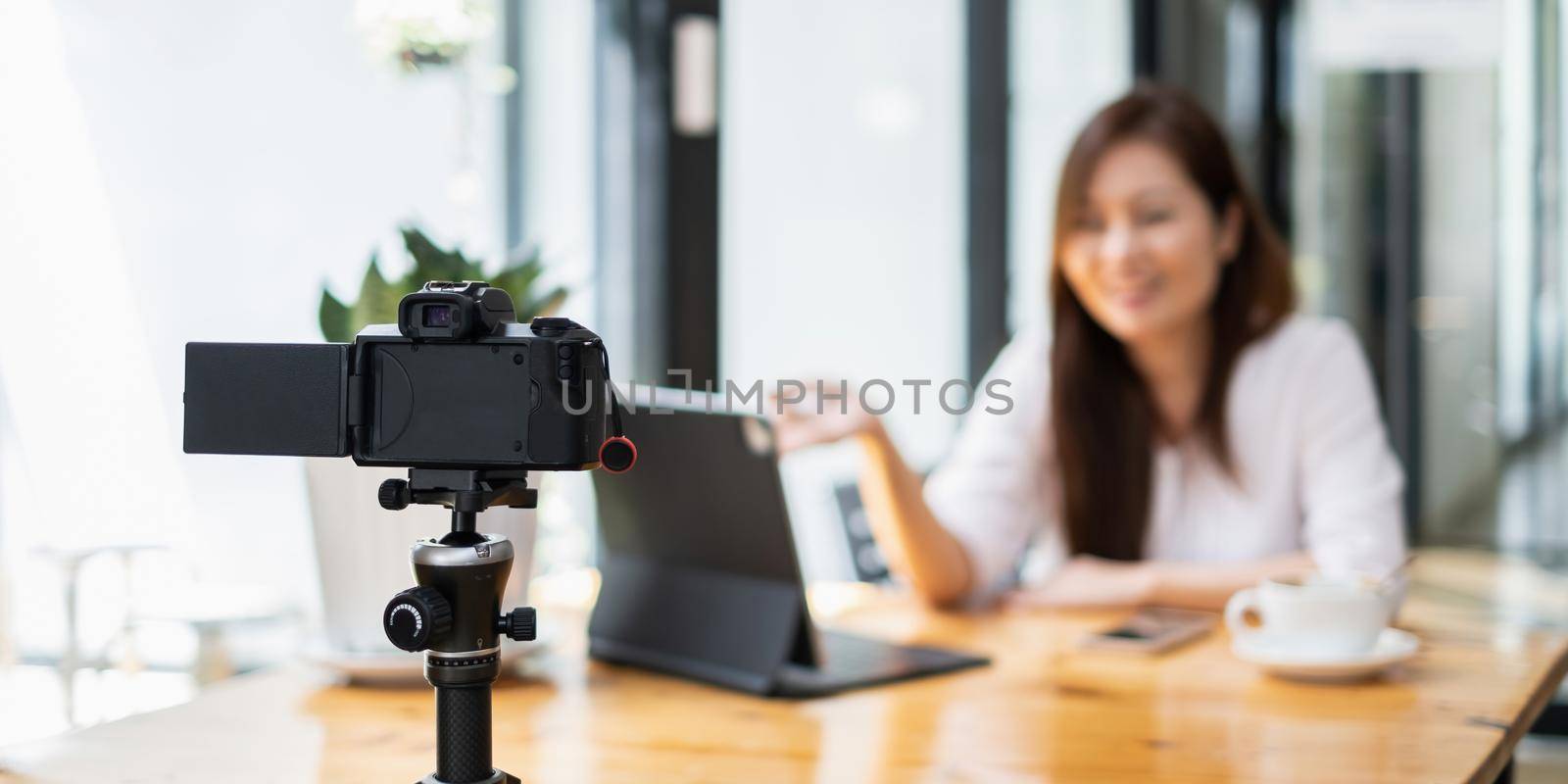 Business woman or blogger recording vlog on digital camera and live stream