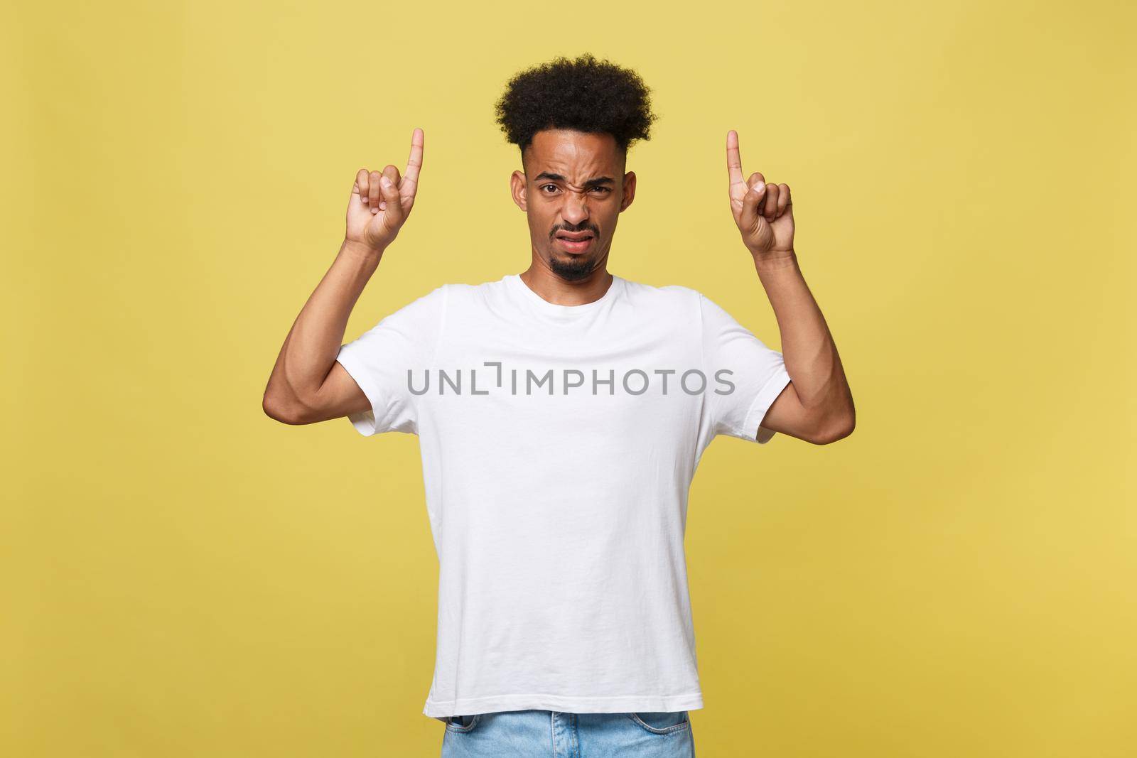 serious dark-skinned African American young man shows a finger upwards.