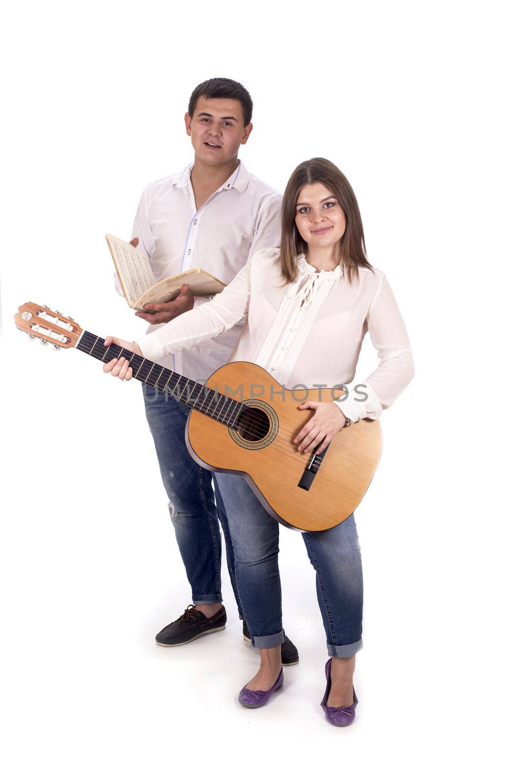 people and music. Pregnant woman and man in white shirts and jeans with guitar on white background by aprilphoto