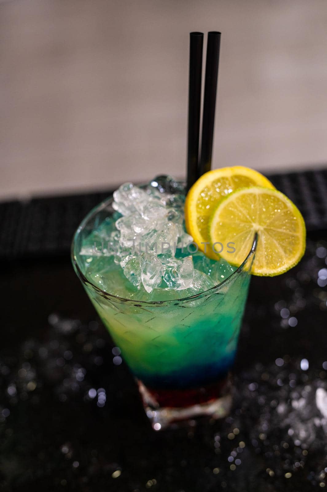 composition of various cocktails on the counter in strong colors and fruit on the head