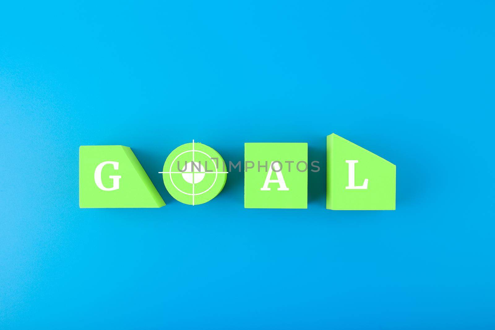 Goal single word written on green geometric figures on blue background by Senorina_Irina