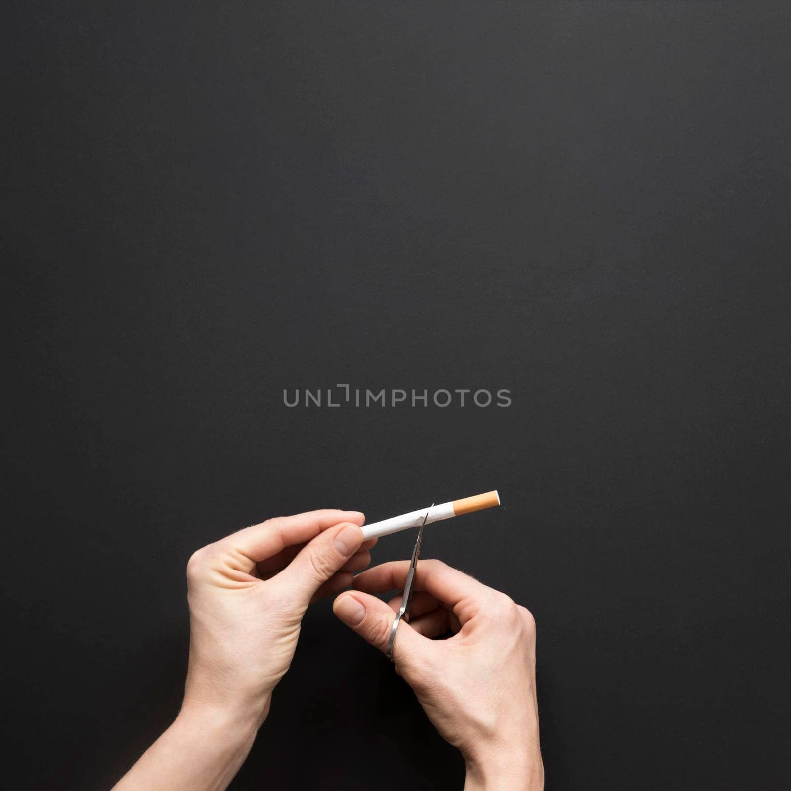 top view hand cutting cigarette. Beautiful photo