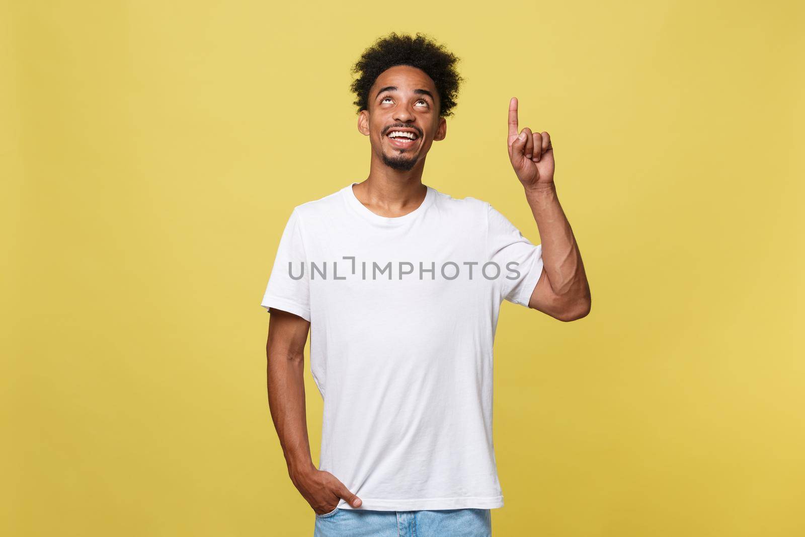 African american man with beard pointing away side with finger isolated over yellow background