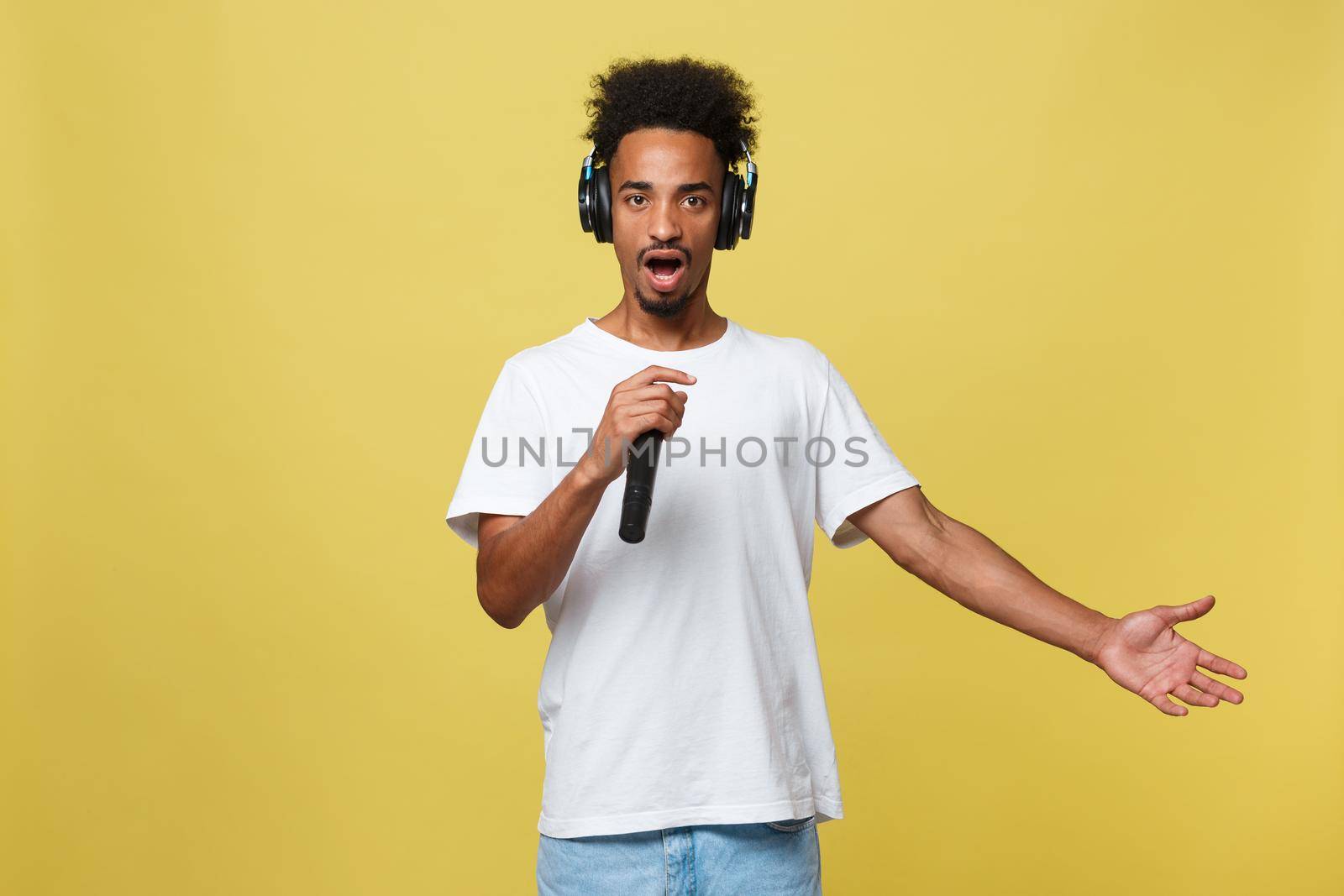 young handsome african american boy singing opera emotional with microphone