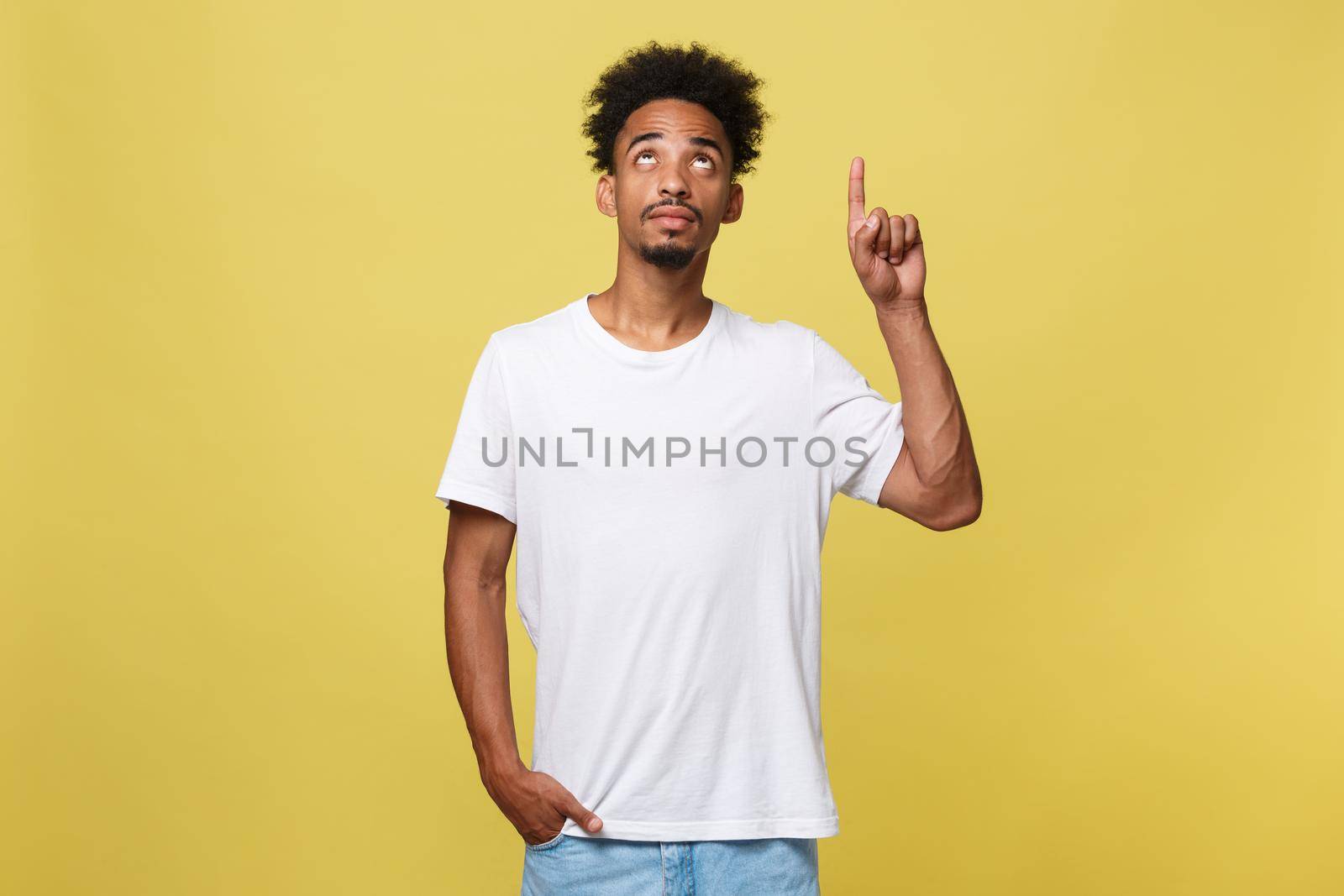 Young handsome african american man over yellow background pointing upwards