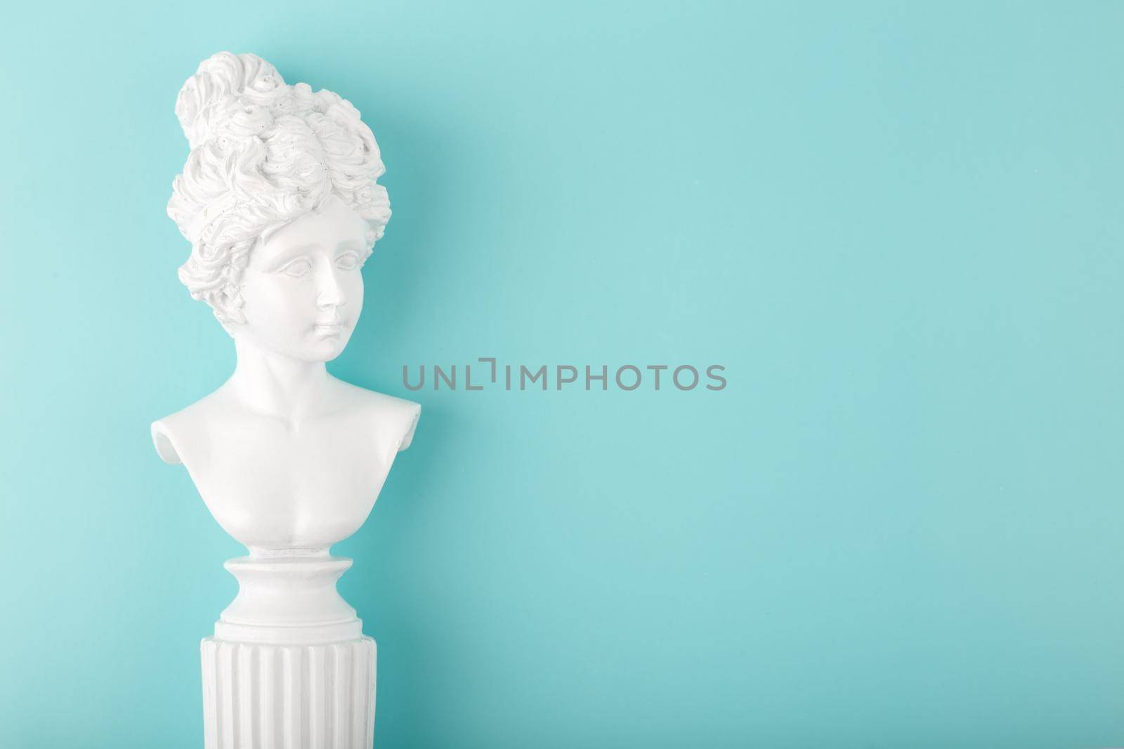 White gypsum classic woman figure on tiffany blue background with copy space. Template for trendy design of postcard, banner, flyer or invitation 