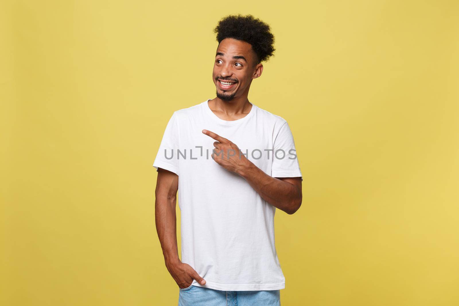 Young handsome african american man over yellow background pointing upwards