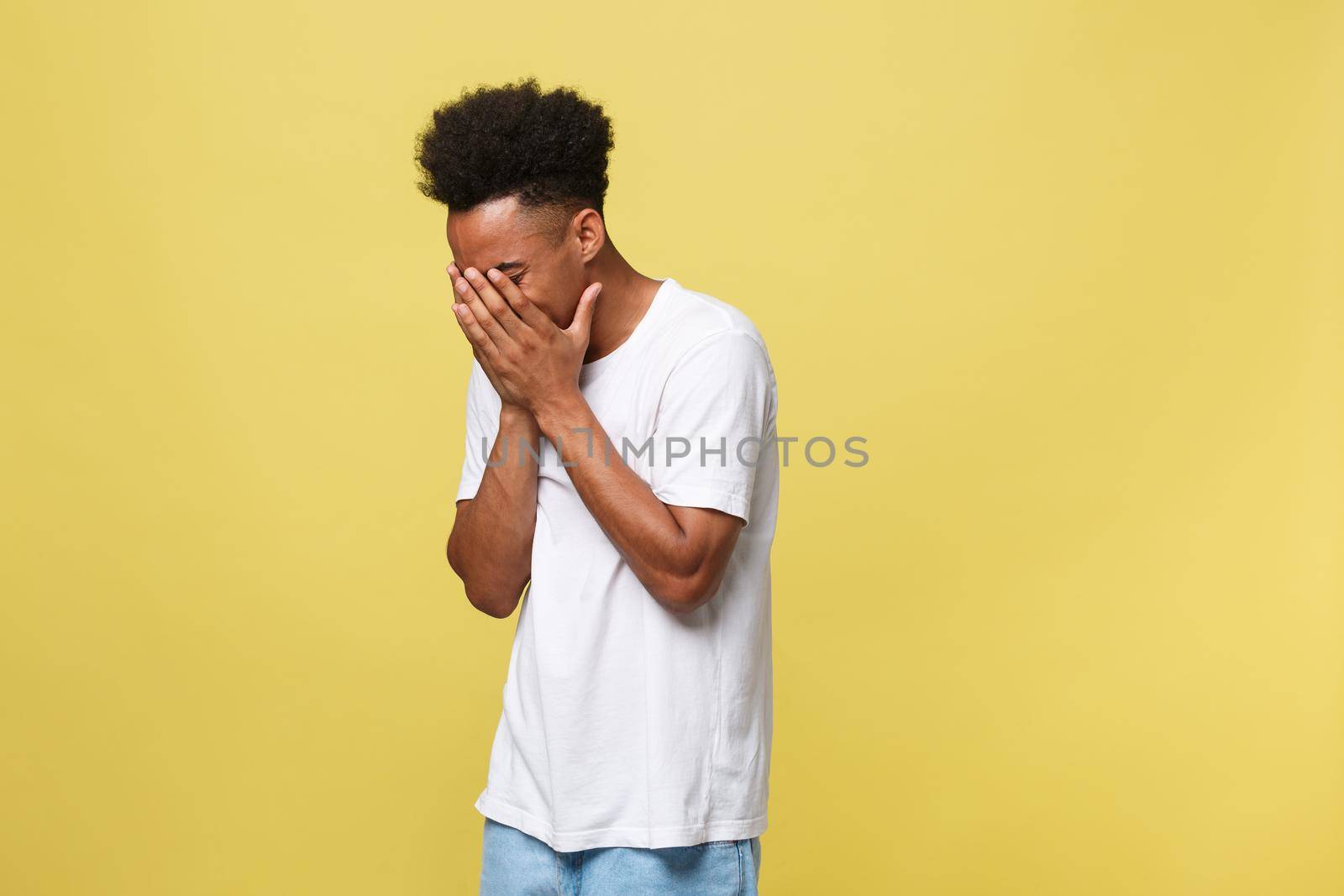 Closeup portrait man with sad expression, isolated on yellow wall background. Human emotions, body language, life perception. Duh moment