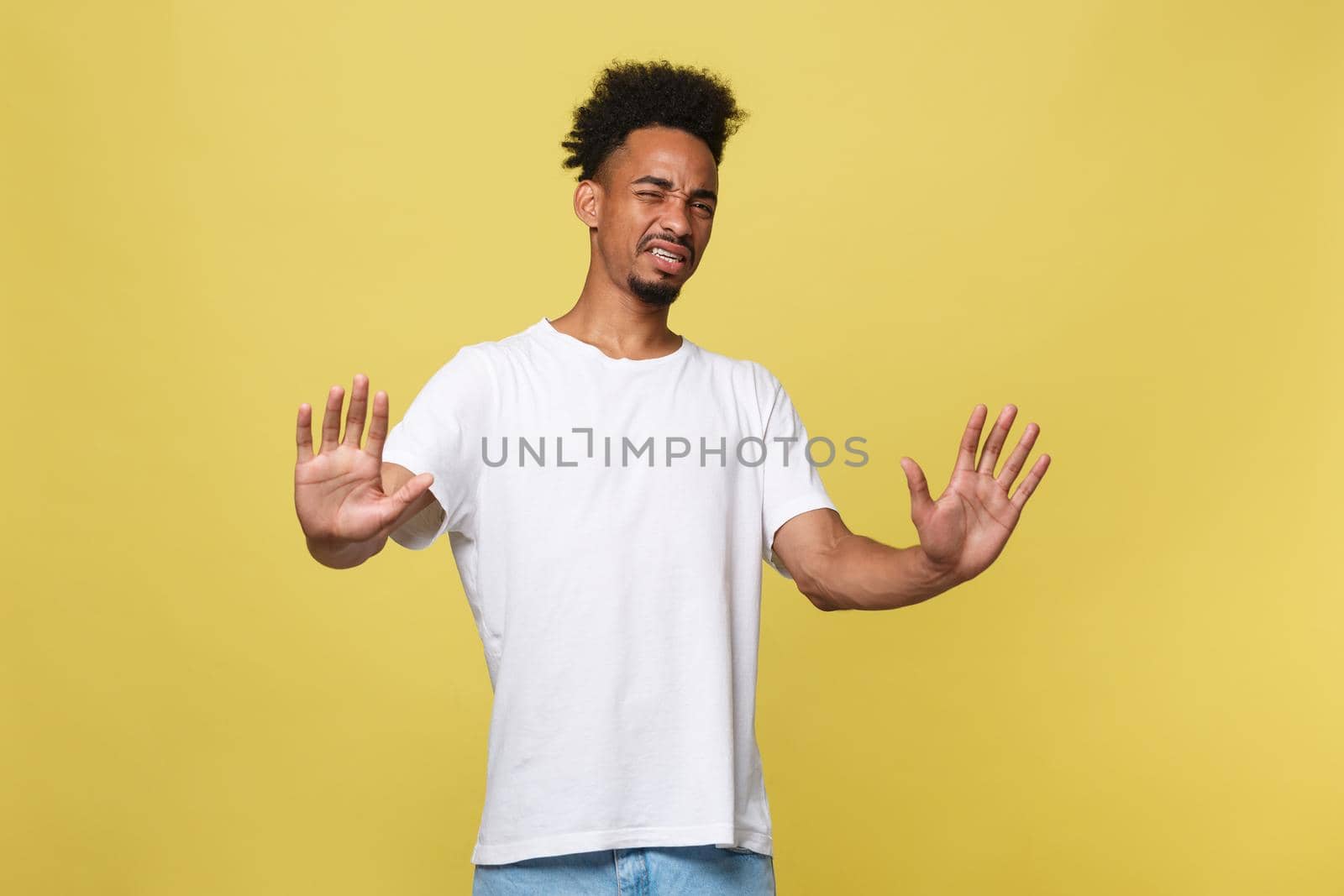 Portrait furious angry annoyed displeased young man raising hands up to say no stop right there isolated orange background. Negative human emotion, facial expression, sign, symbol, body language