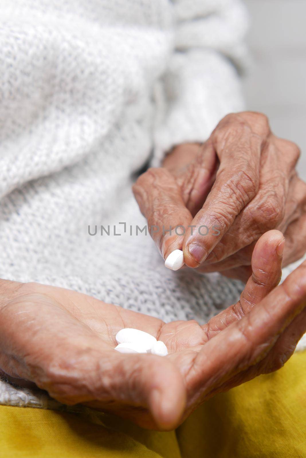 senior women hand's taking medicine, close up .