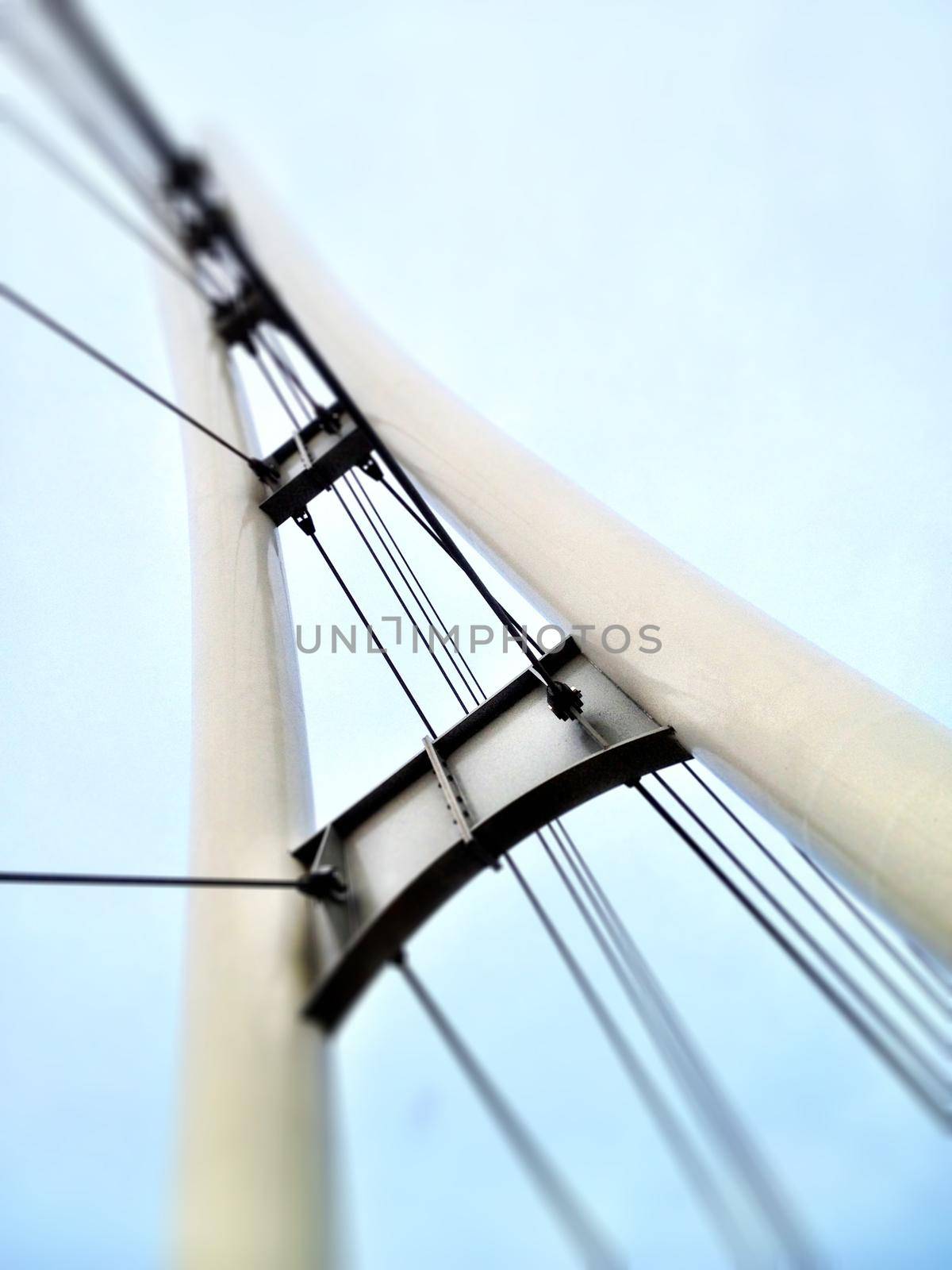 Image of Worm's eye view of a white bridge with suspension cord