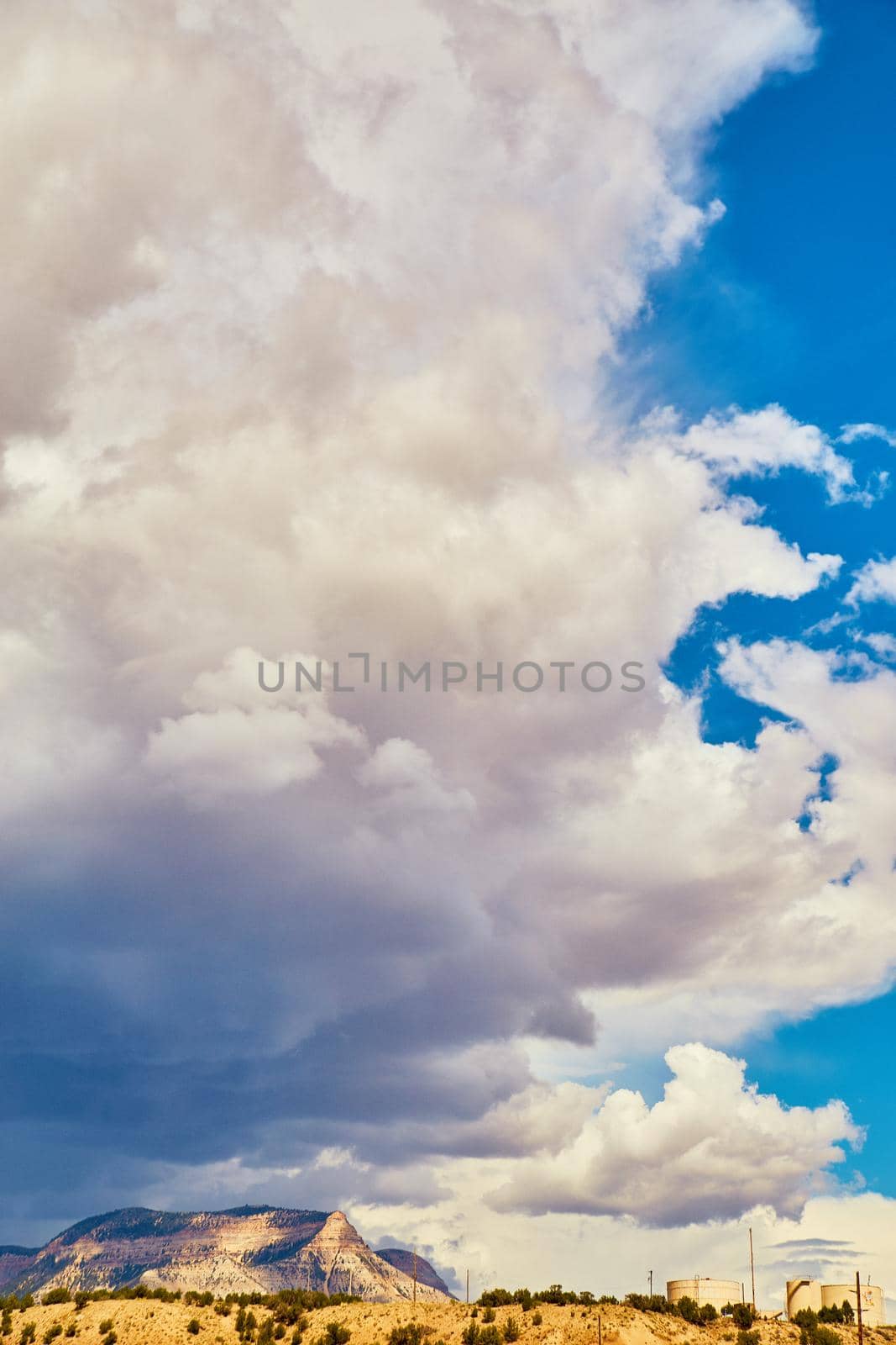 Image of Vertical landscape of desert mountains with large storm clouds looming overhead