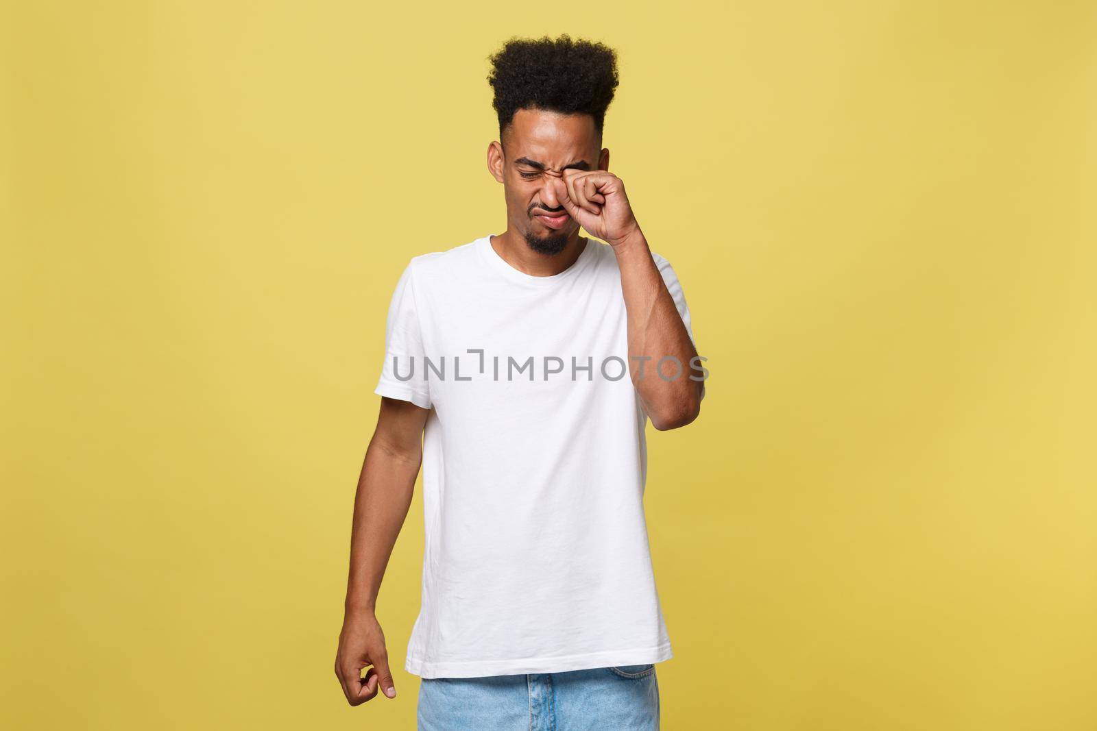 Closeup portrait man with sad expression, isolated on yellow wall background. Human emotions, body language, life perception. Duh moment. by Benzoix