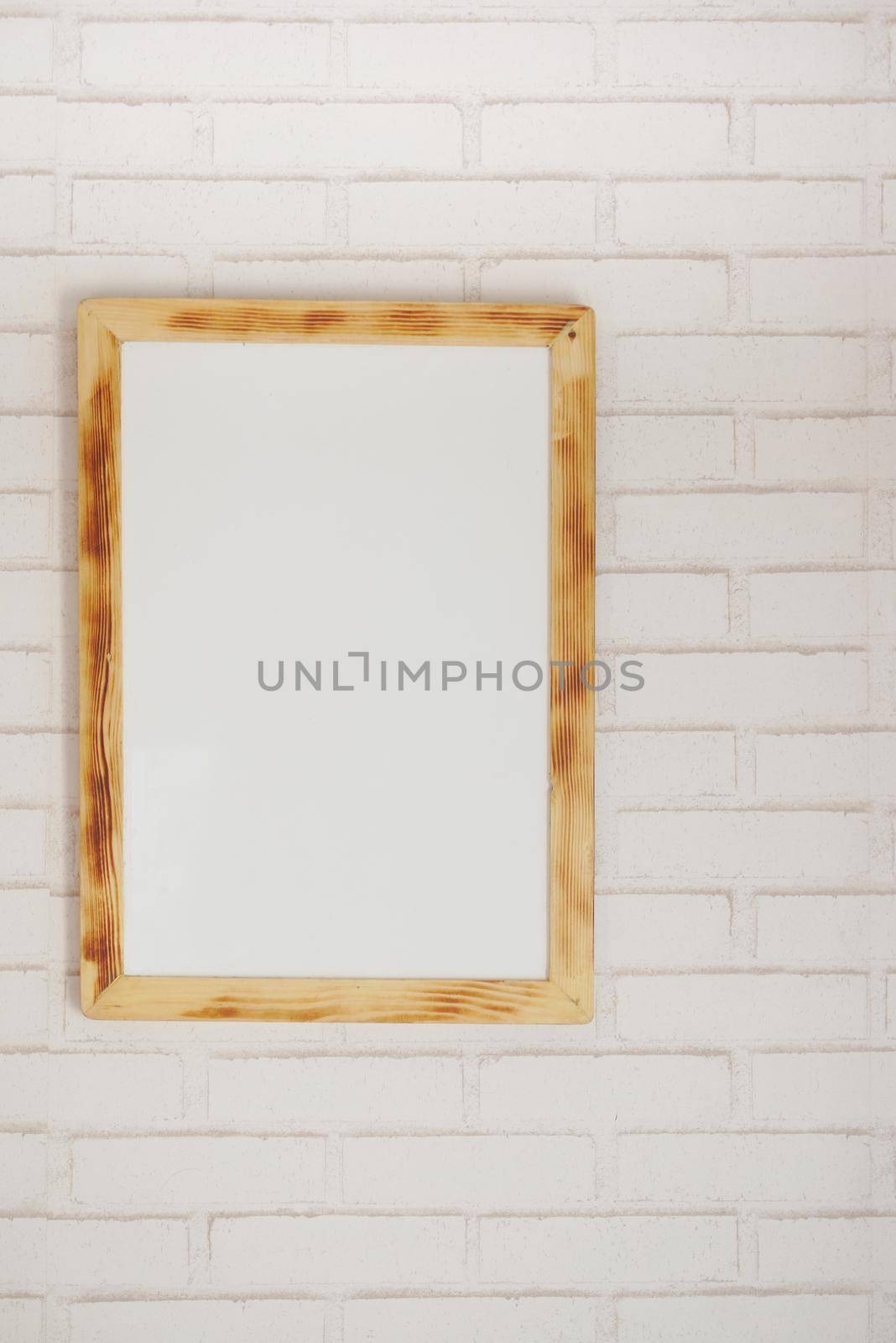 Black frame mockup on table against white wall